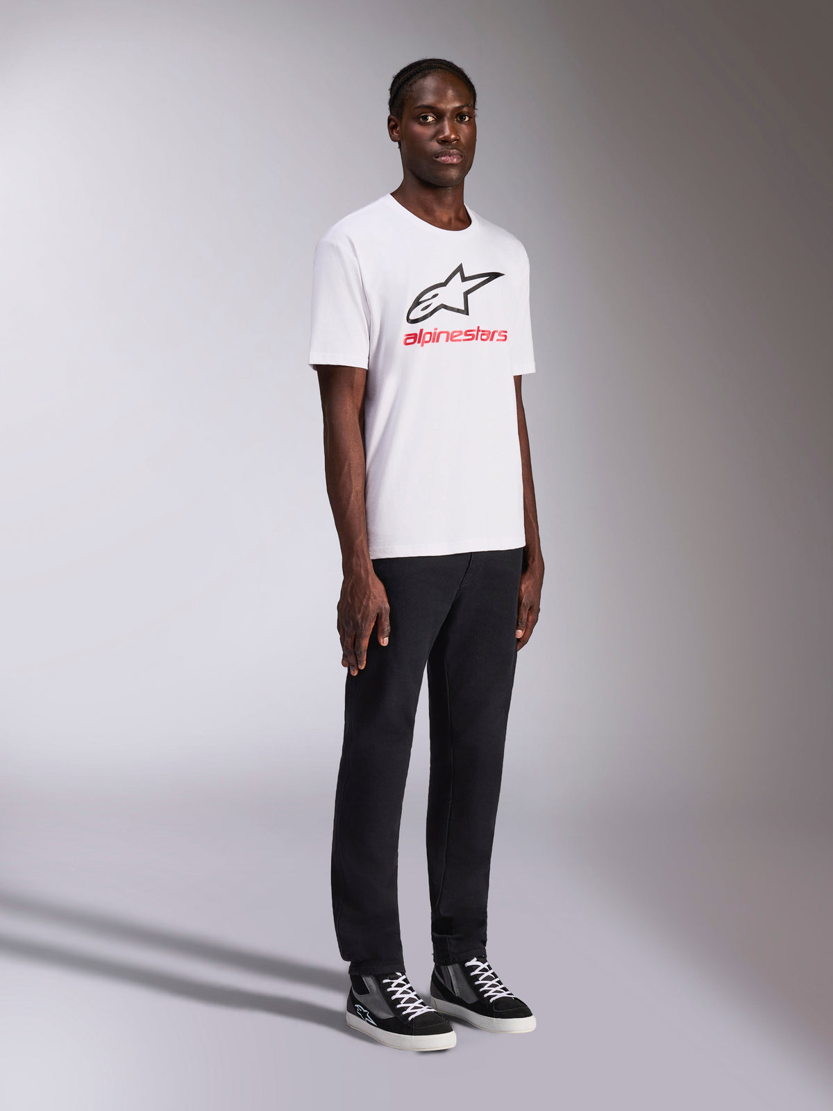 Alpinestars Always 2.0 CSF Tee, Short Sleeve T-Shirt, White, Black Alpinestars logo and Red lettering on chest, worn by model with black pants and sneakers, Casual Motorsport Streetwear
