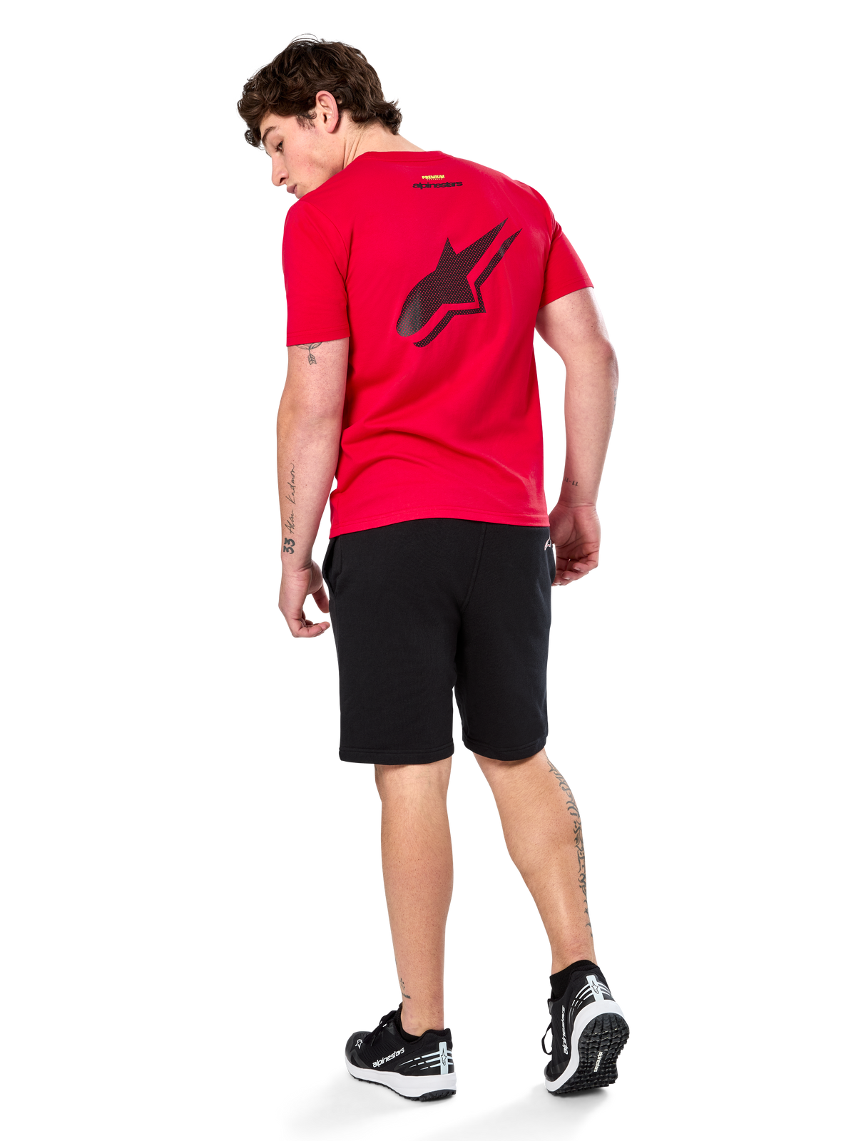 Alpinestars Formulate Csf Tee, Short Sleeve T-Shirt, Red, Large black perforated Astars logo on the back, worn with black shorts and sneakers, casual motorsport-inspired streetwear
