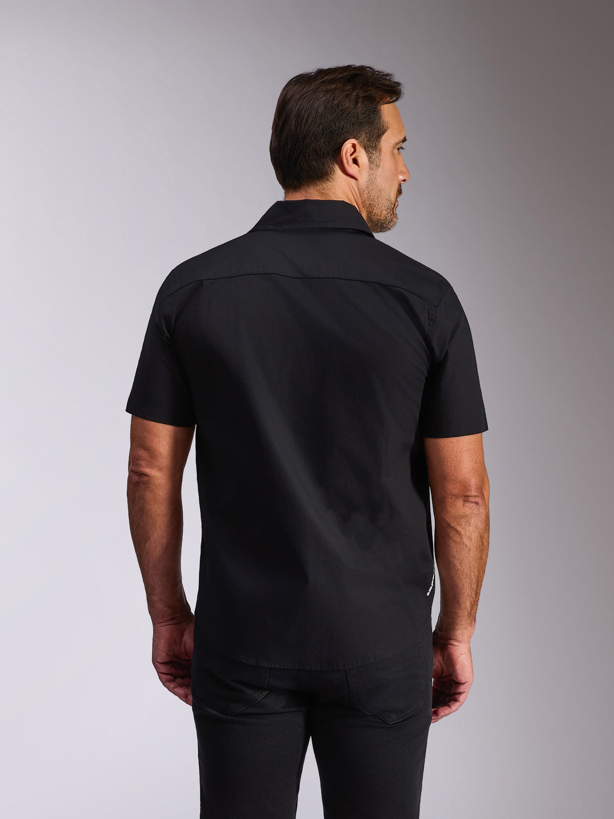 Alpinestars Strive Woven Shirt, Black Short Sleeve Button-Down, Rear view showing back yoke and tailored fit, casual motorsport-inspired streetwear