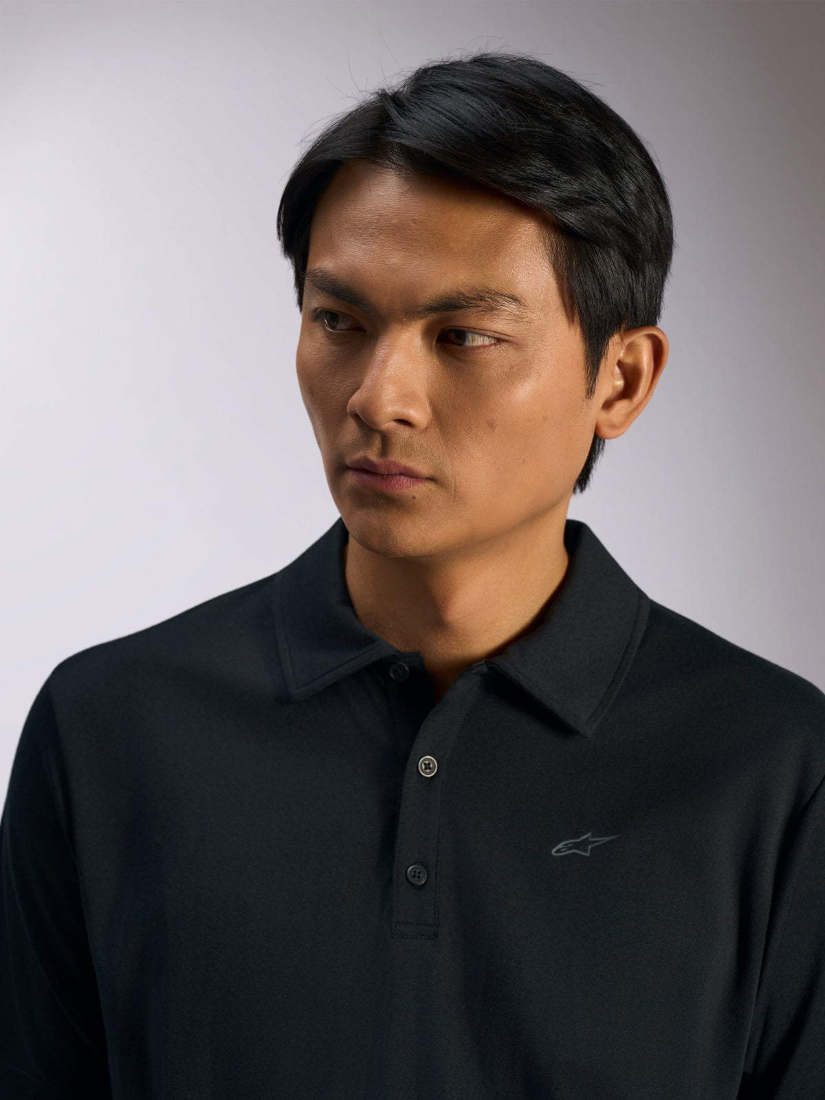 Alpinestars Impetus Sport Polo, Black Sportswear Polo Shirt, mock mesh fabric with three-button placket and self collar, subtle Astars logo on chest, casual motorsport lifestyle apparel