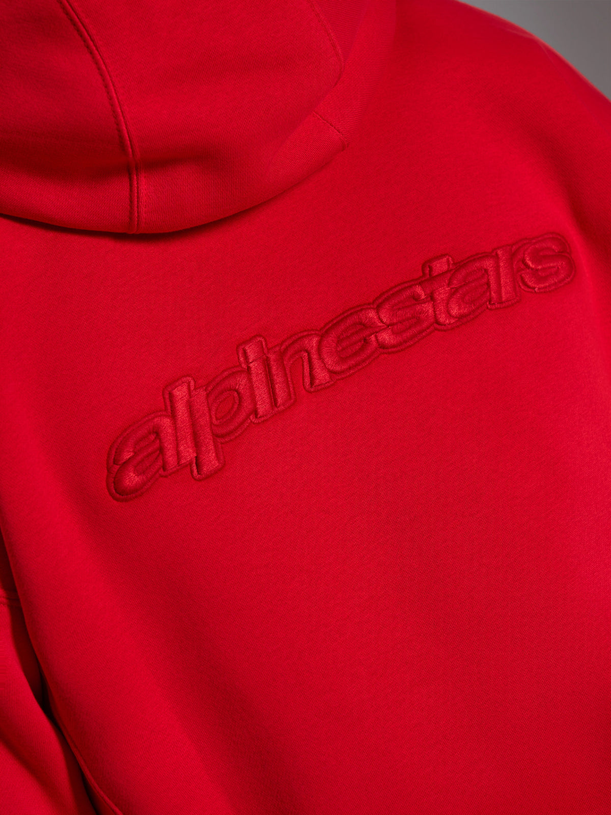 Alpinestars Emergent Oversized Hoodie, Red, close-up of back showing tonal 3D embroidered Alpinestars word logo, raised monochromatic branding on fleece fabric