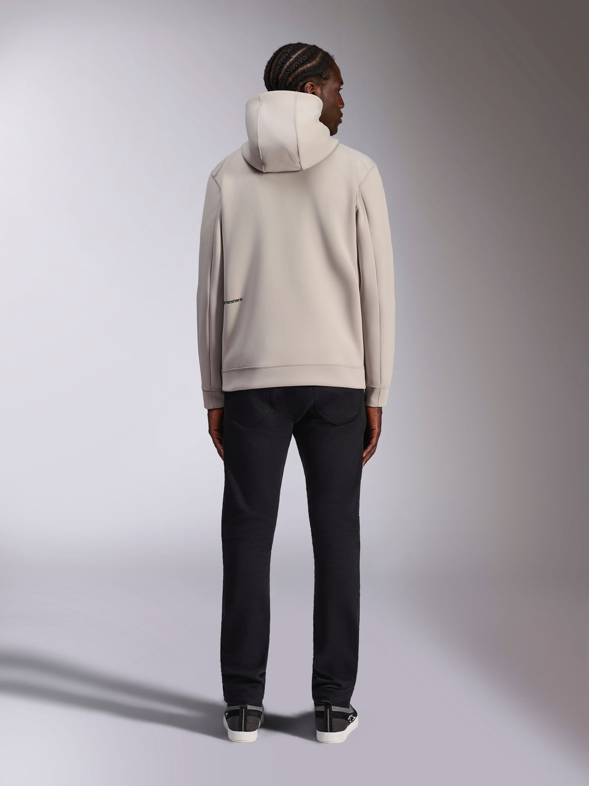 Alpinestars Cypher Hoodie, Cement light gray, back view of man wearing full-zip fleece hoodie with high-neck hood and Alpinestars branding on the back, casual motorsport-inspired streetwear paired with black pants