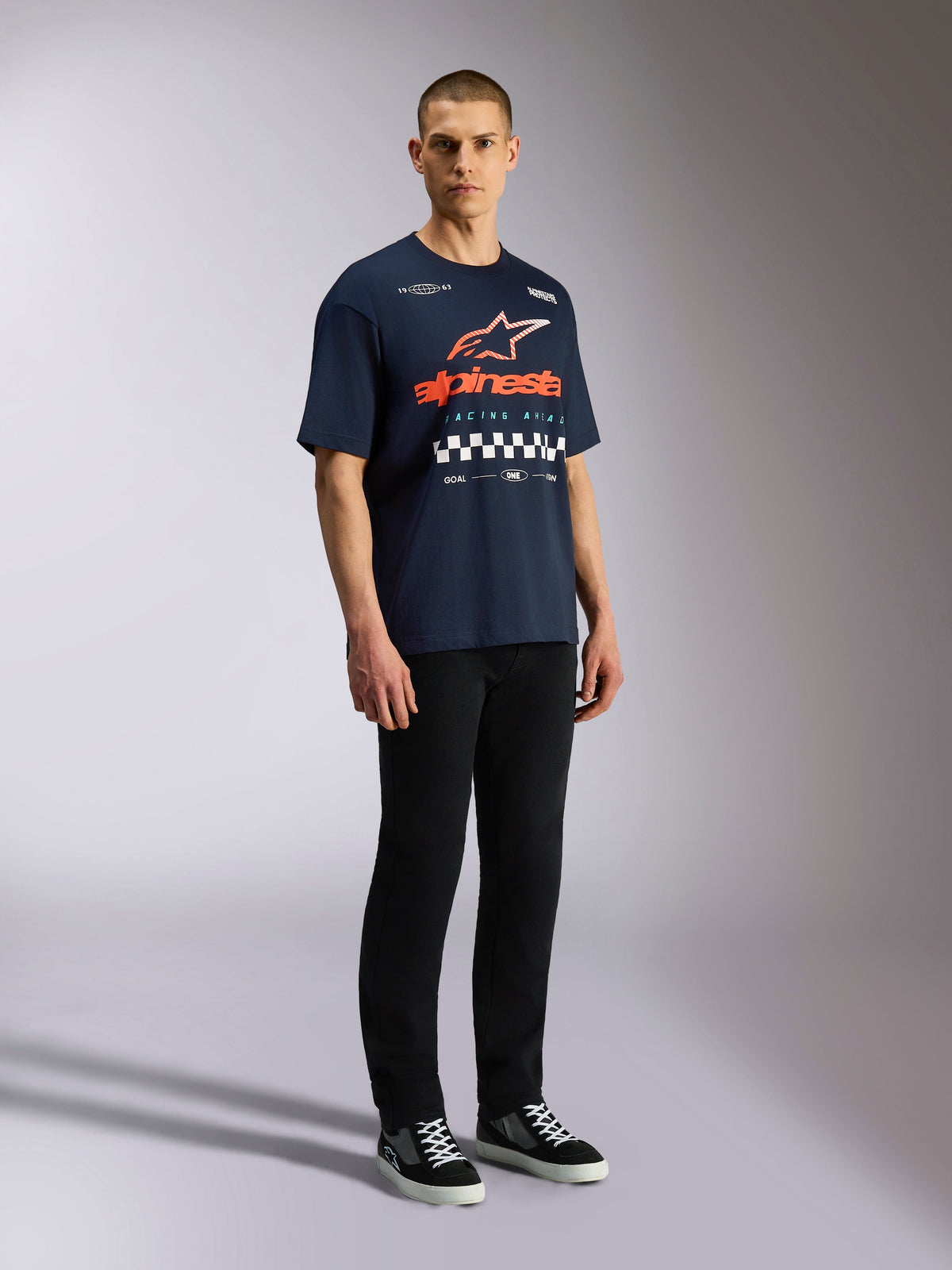 Alpinestars Aplomb Oversized CSF Tee, Short Sleeve T-Shirt, Navy, Large orange and white Astars logo with checkered graphic, casual motorsport-inspired streetwear