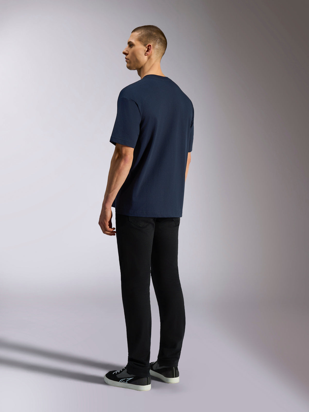 Alpinestars Aplomb Oversized CSF Tee, Short Sleeve T-Shirt, Navy, back view on model, worn with black pants and sneakers, casual motorsport-inspired streetwear