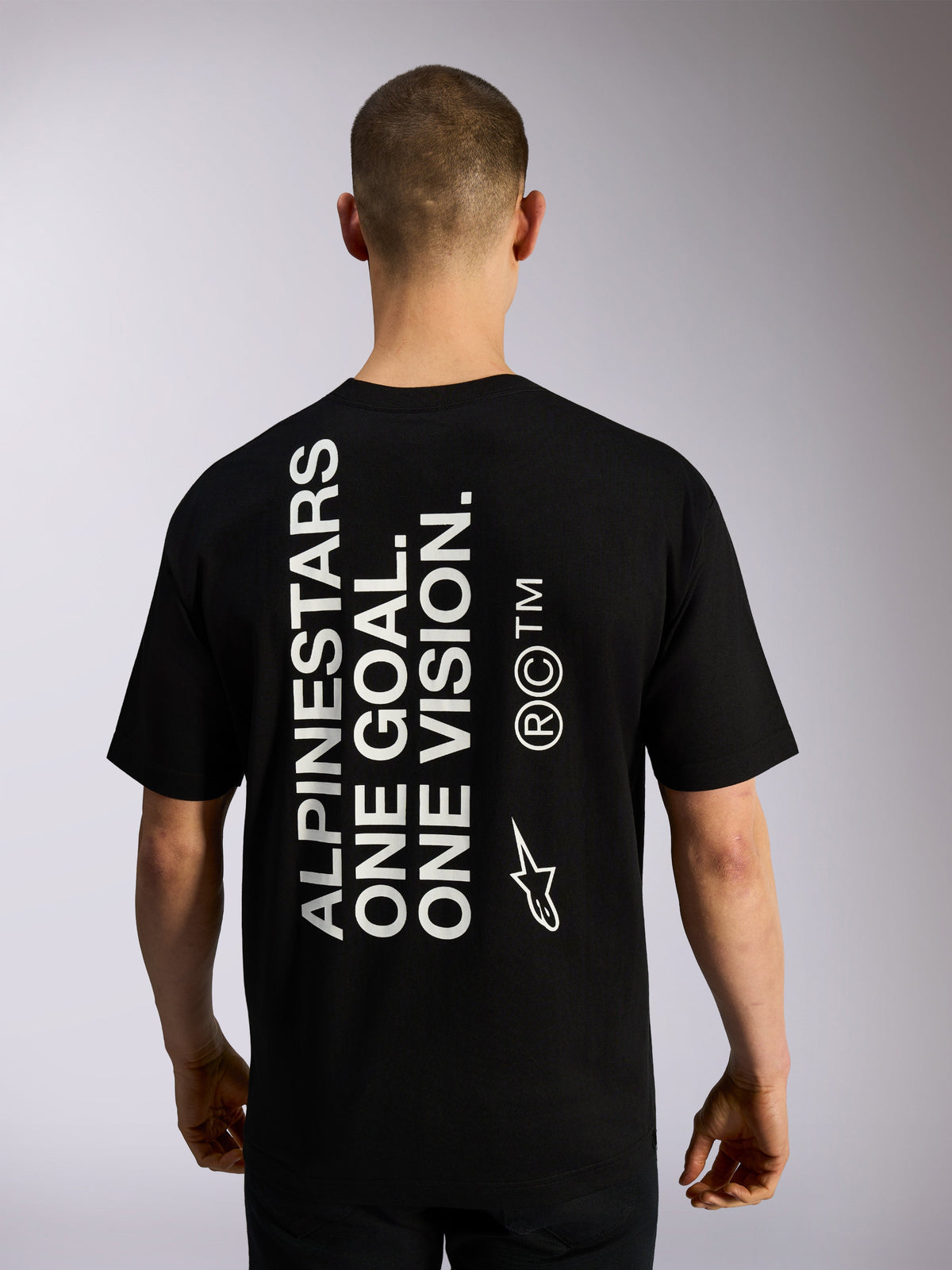 Alpinestars One Oversized CSF Tee, Short Sleeve T-Shirt, Black, back view featuring large vertical white 'ALPINESTARS ONE GOAL. ONE VISION.' text and branding logos, casual motorsport streetwear