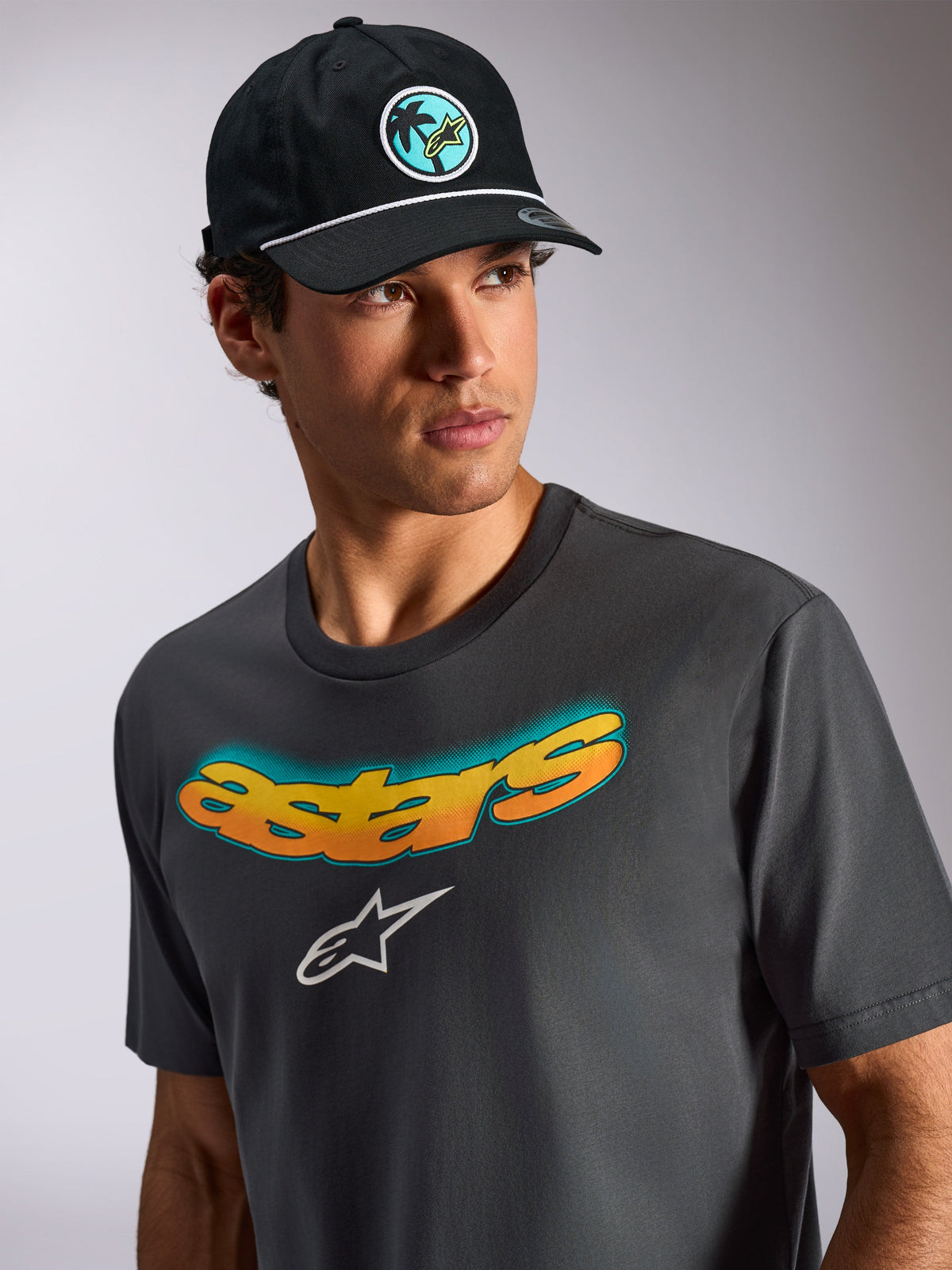 Alpinestars Ellipsoid CSF Tee, Short Sleeve T-Shirt, Charcoal Gray, Curved Astars Wordmark with Yellow and Orange Gradient, White Astars Logo, Casual Motorsport Streetwear Lifestyle