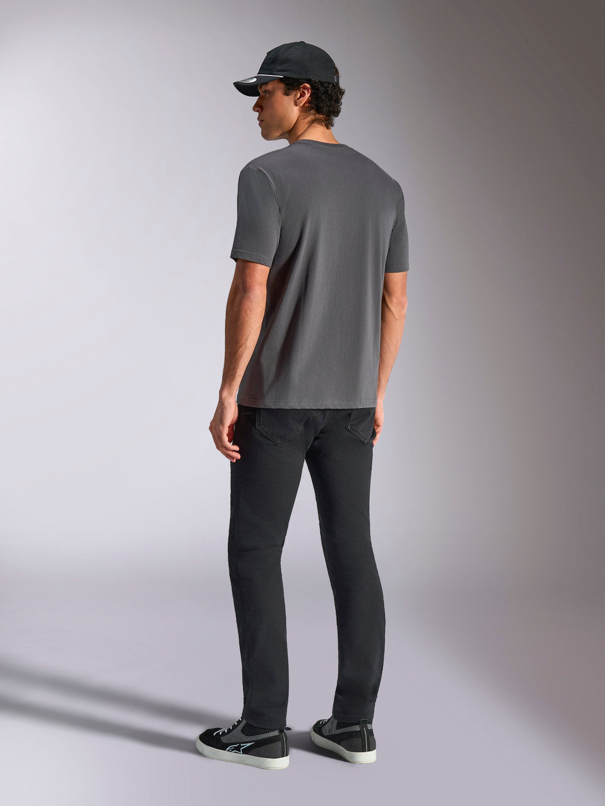 Alpinestars Ellipsoid CSF Tee, Short Sleeve T-Shirt, Charcoal Gray, back view, worn by model with black pants and black baseball cap, casual motorsport streetwear