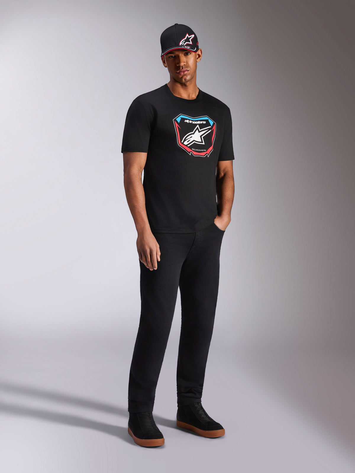 Alpinestars Plate CSF Tee, Short Sleeve T-Shirt, Black, colorful front MX plate graphic with star logo, worn by model with black logo cap and pants, casual motorsport-inspired streetwear