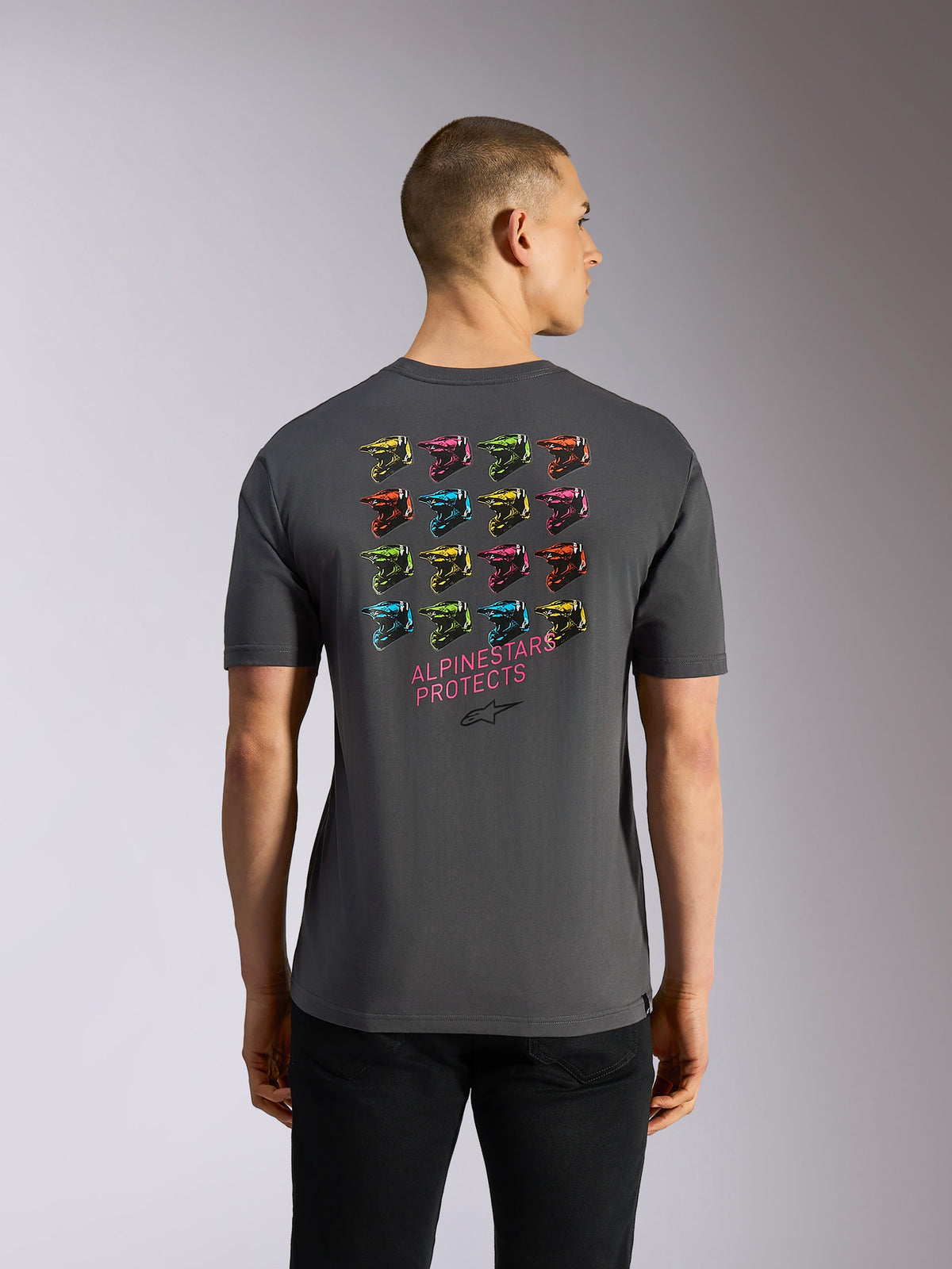 Alpinestars Pop Helmet CSF Tee, Short Sleeve T-Shirt, Gray, rear view featuring a vibrant grid of 16 colorful M10 helmets and pink "ALPINESTARS PROTECTS" text on the back, casual motorsport-inspired streetwear