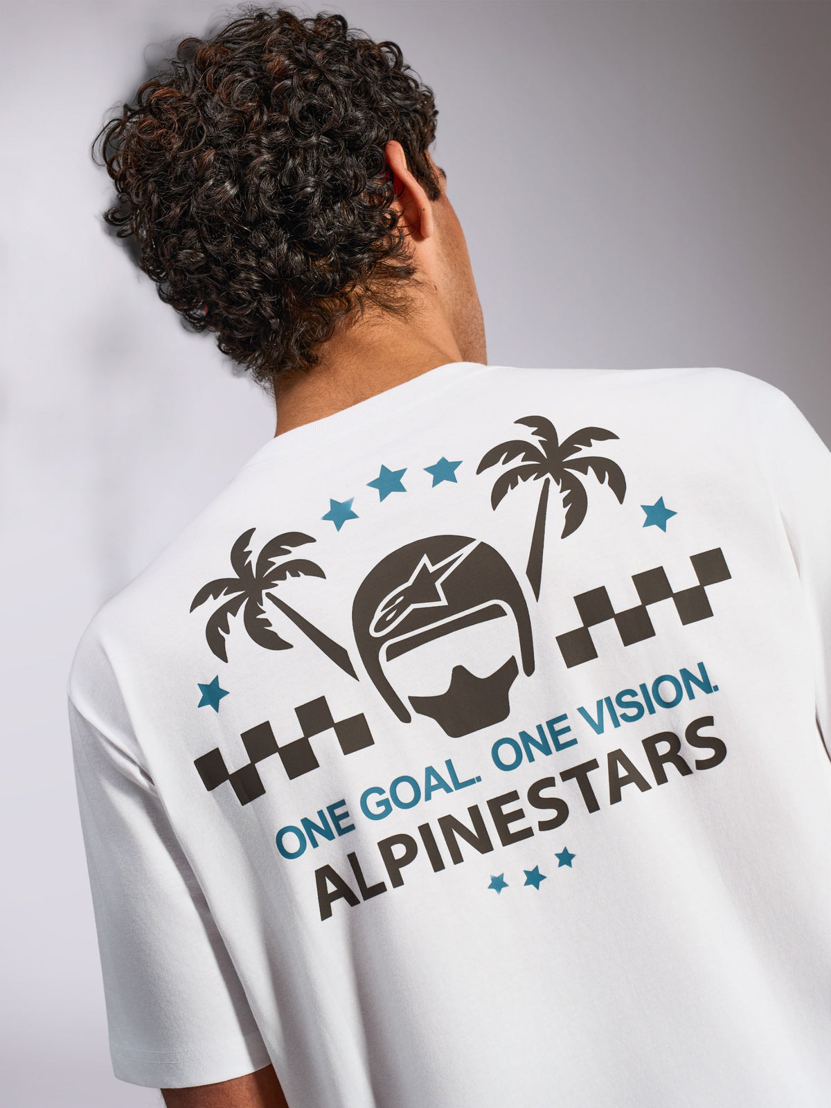 Alpinestars Order CSF Tee, Short Sleeve T-Shirt, White, Back view featuring graphic with helmet, palm trees, and 'ONE GOAL. ONE VISION.' text, Casual Motorsport Streetwear
