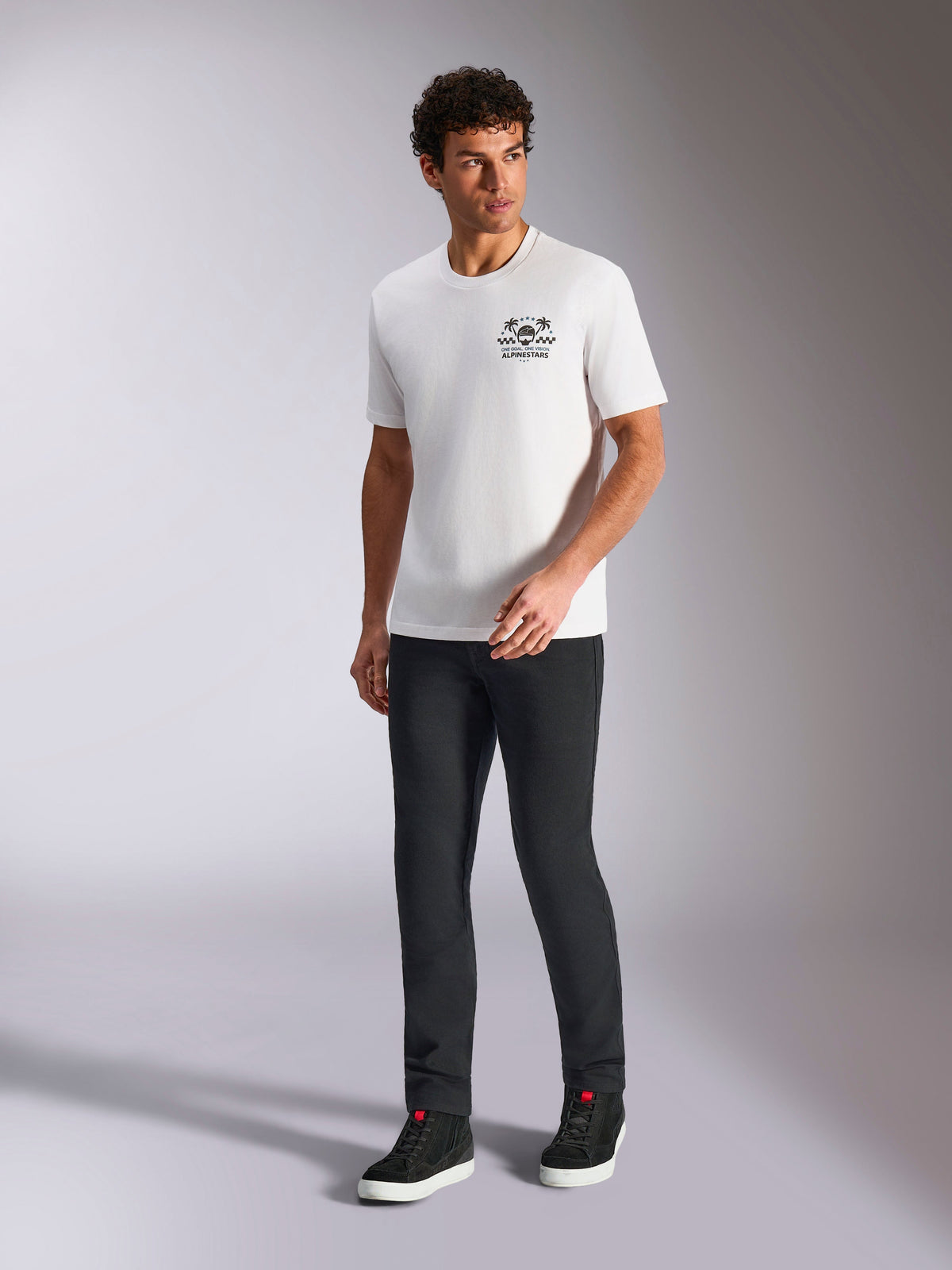 Alpinestars Order CSF Tee, Short Sleeve T-Shirt, White, Helmet and Palm Trees Logo, Worn with Black Pants and High-Top Sneakers, Casual Motorsport Streetwear