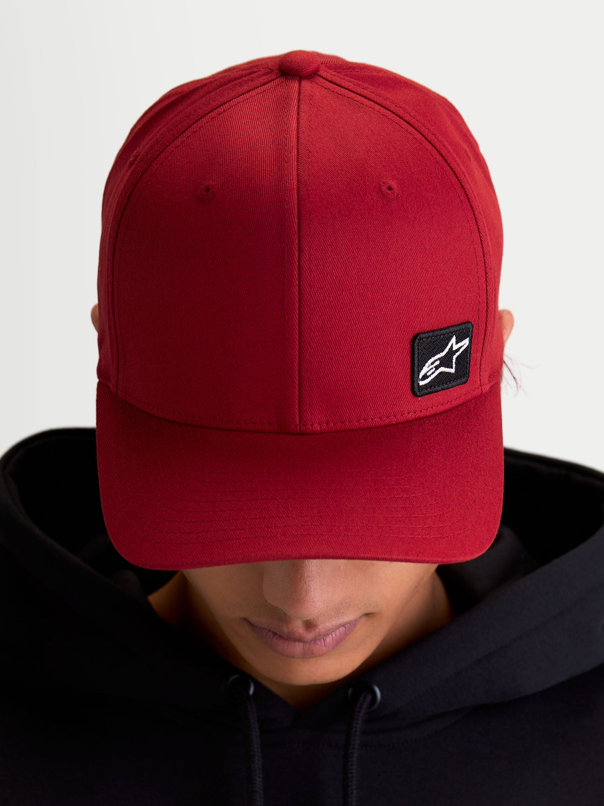 Alpinestars Pivot Hat, Casual Sportswear Baseball Cap, Dark Red, Unisex, featuring a curved bill, structured crown, and a small black Astars logo embroidered patch on durable twill fabric, on-model view.