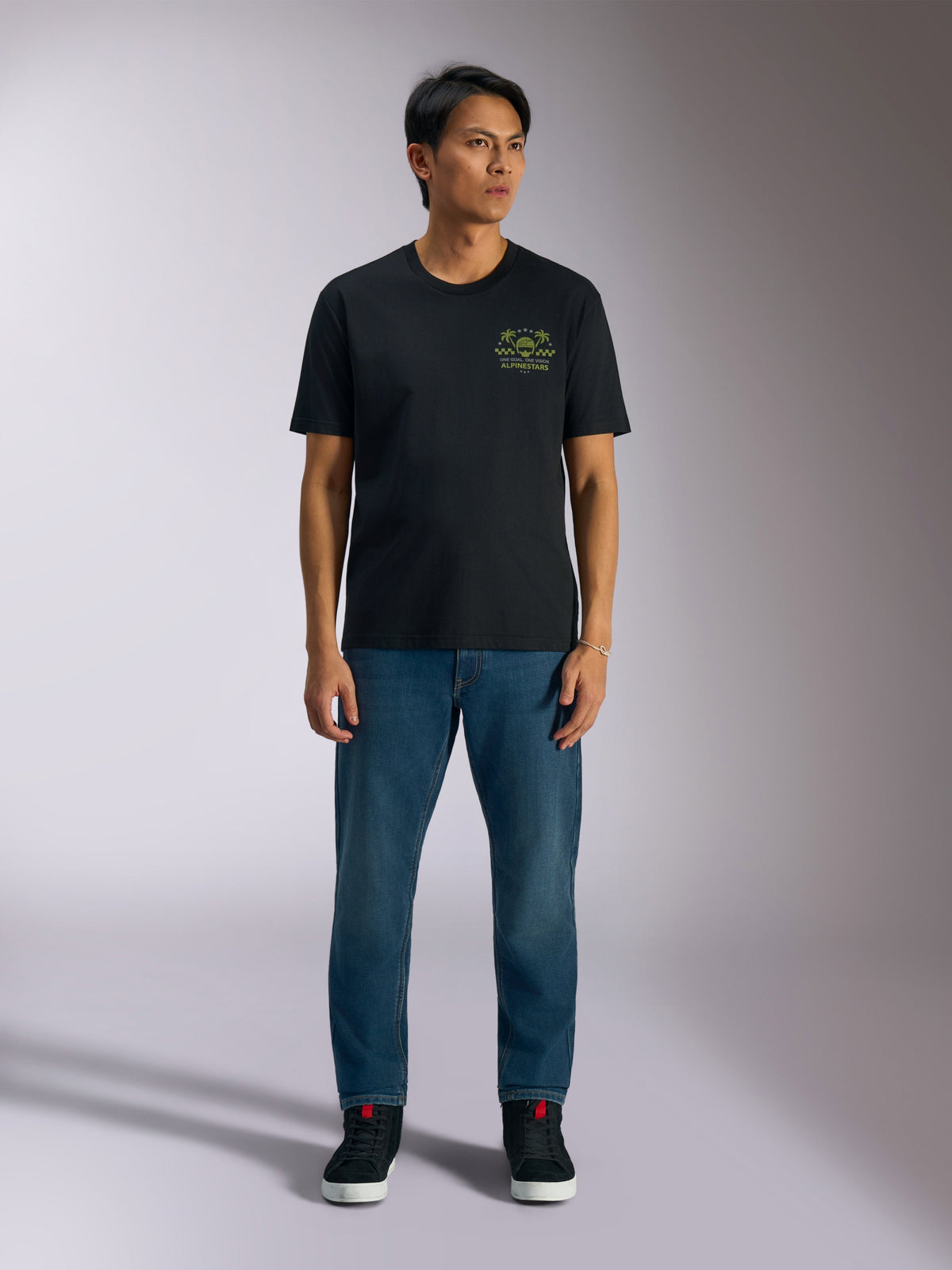 Alpinestars Order CSF Tee, Short Sleeve T-Shirt, Black, Lime Green Graphic with Helmet and Palm Trees on chest, worn with blue jeans and black sneakers, Casual Motorsport Streetwear