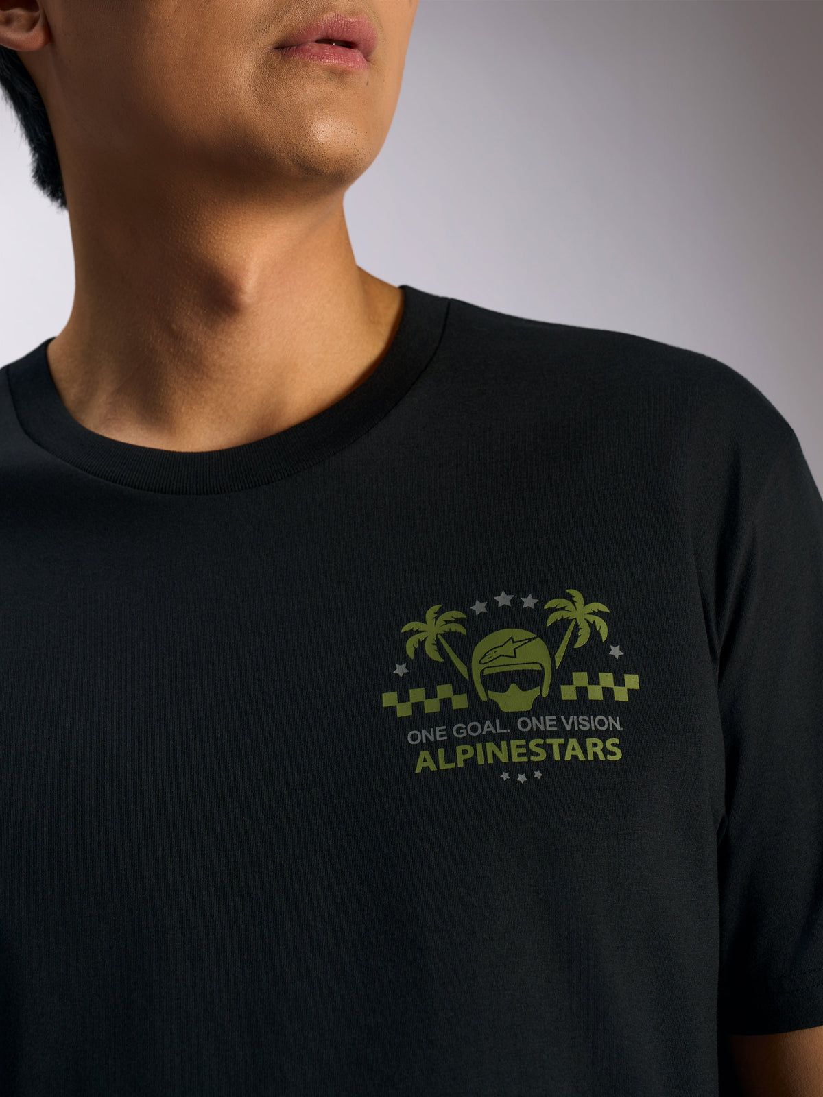 Alpinestars Order CSF Tee, Short Sleeve T-Shirt, Black, olive green helmet and palm tree graphic on chest with 'ONE GOAL. ONE VISION.' text, casual motorsport streetwear