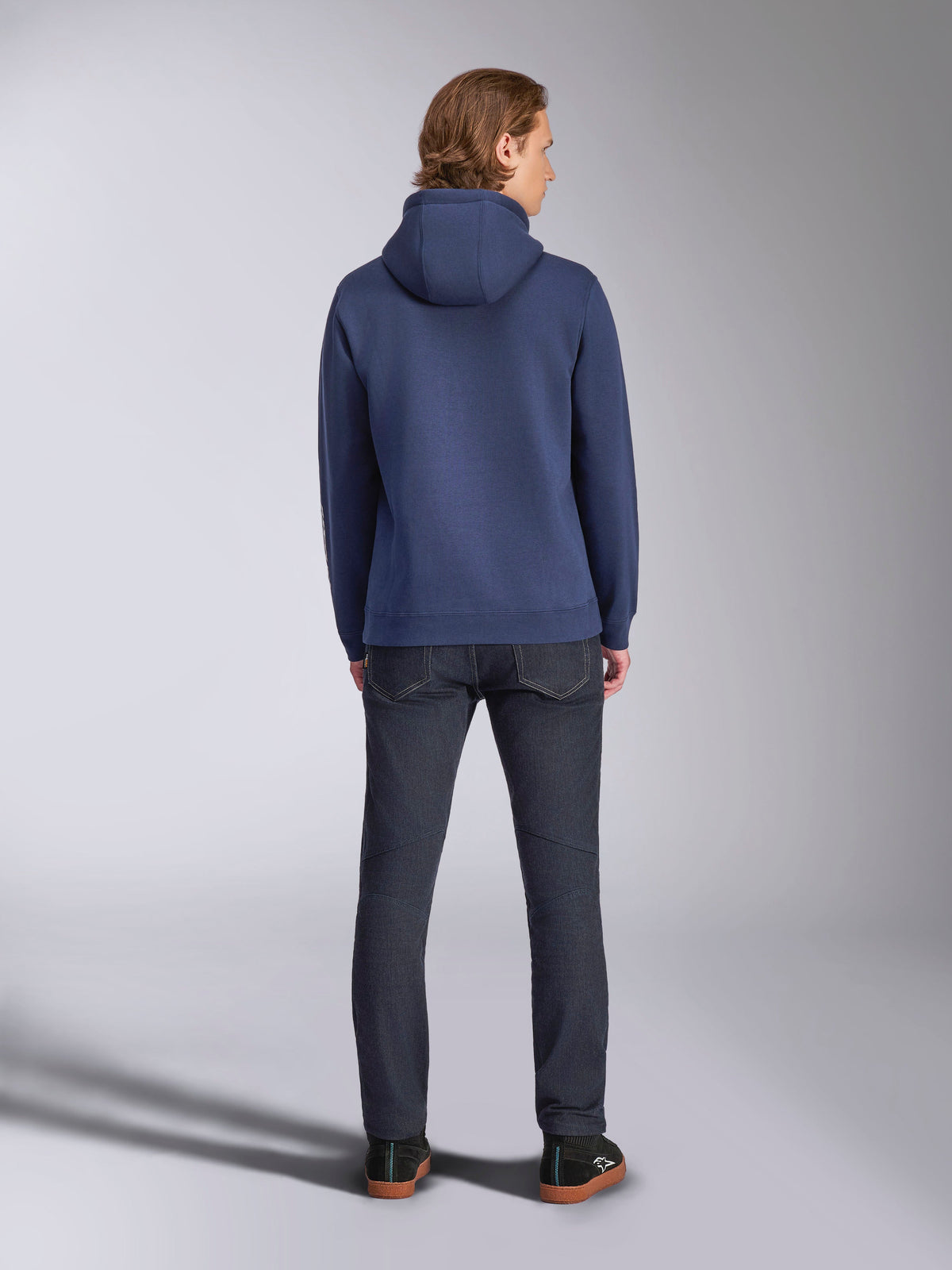 Alpinestars Harken Hoodie, Navy Blue, Rear View, Pullover Fleece Hoodie, Casual Sportswear, worn with dark denim jeans, showing the hood and ribbed hem