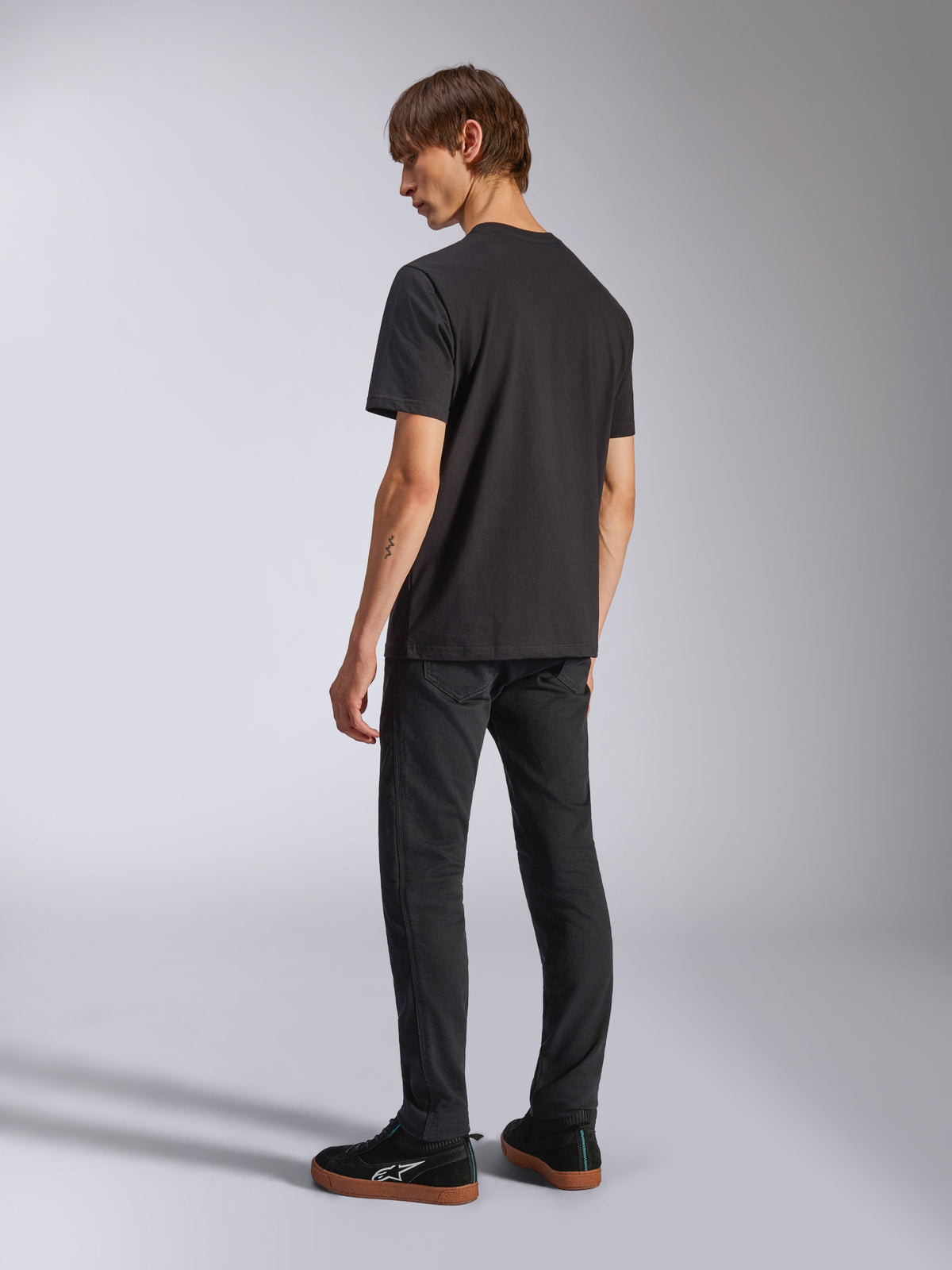 Alpinestars Harken CSF Tee, Short Sleeve T-Shirt, Black, back view on model, worn with black pants and black sneakers, casual motorsport streetwear
