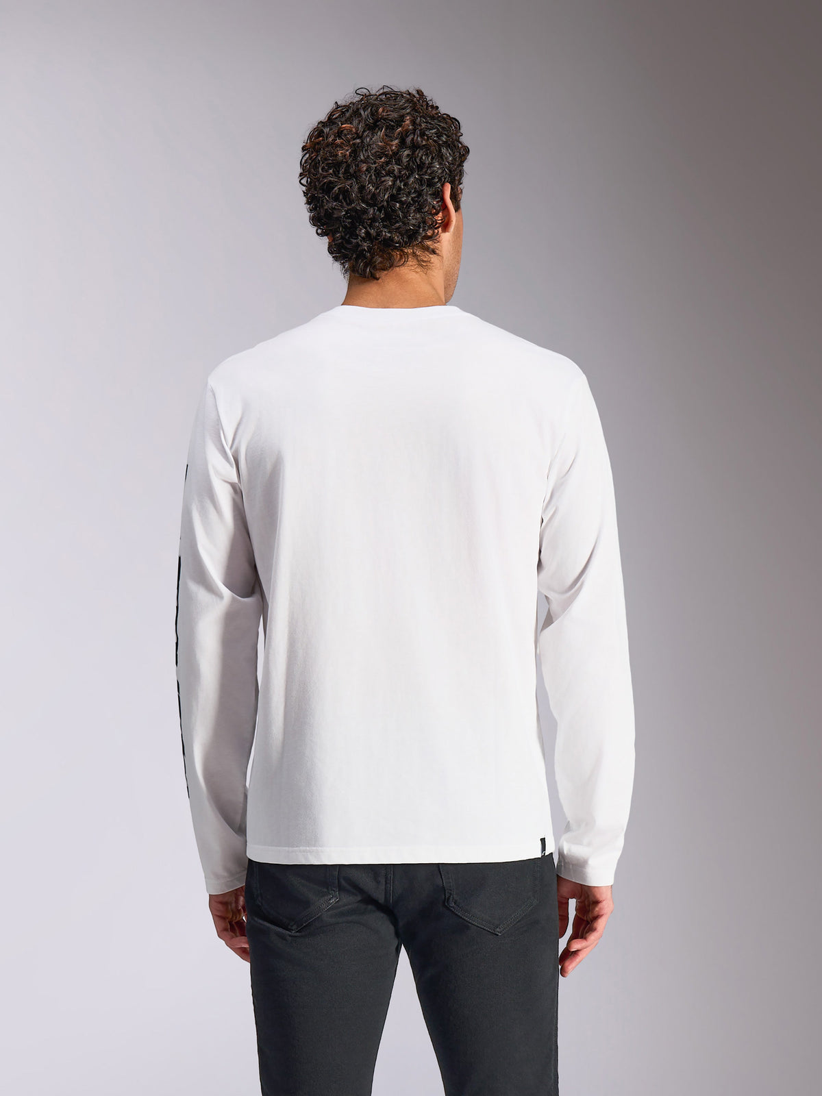 Alpinestars Trackside CSF Tee - Long Sleeve, White, back view on model, paired with black pants, clean white fabric with long sleeves, casual motorsport-inspired streetwear
