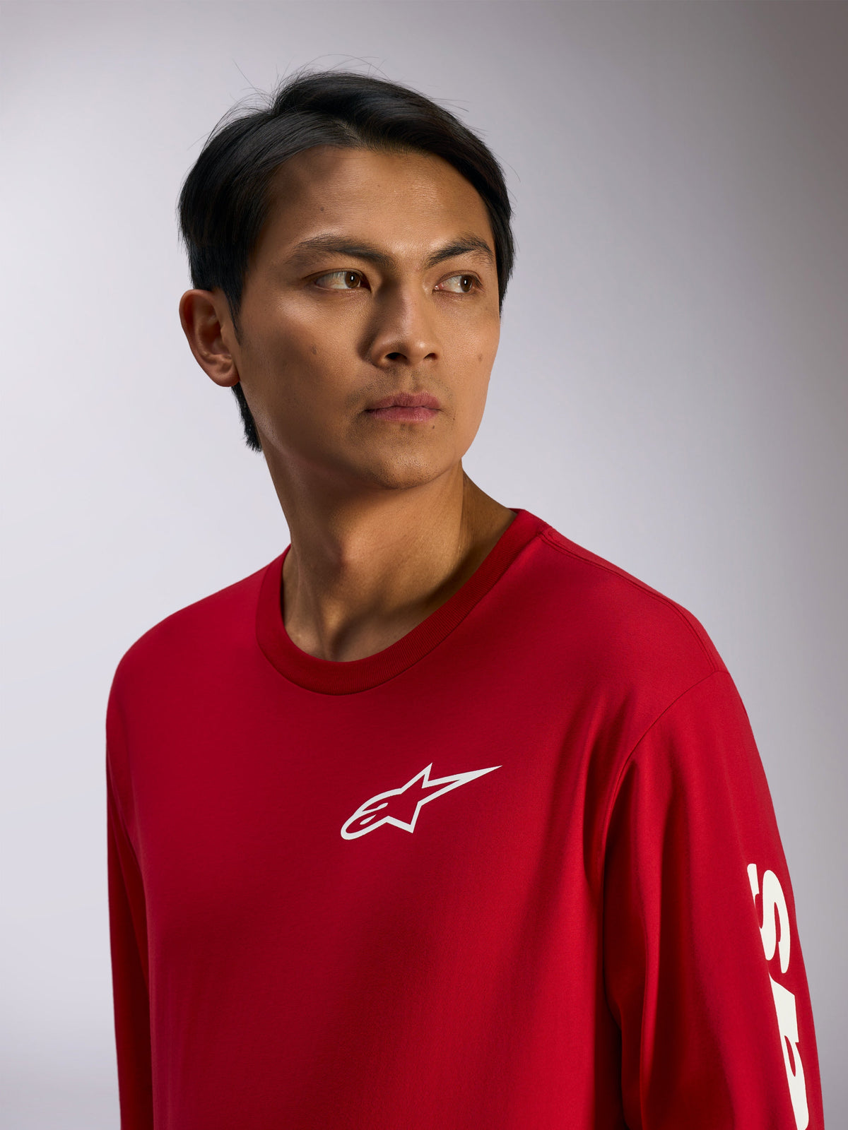 Alpinestars Trackside CSF Tee, Long Sleeve T-Shirt, Red with white Alpinestars logo on chest and lettering on sleeve, casual motorsport streetwear, lifestyle portrait