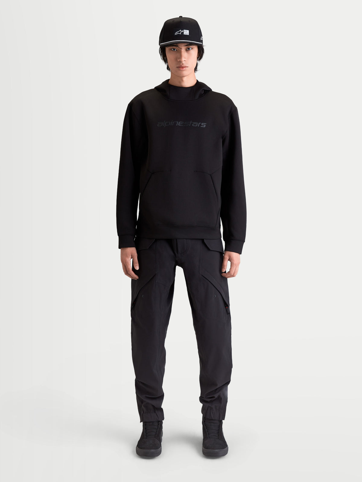 Alpinestars Datrix Hoodie, Men's Premium Sportswear Pullover, Black, featuring tonal HD Alpinestars branding, tri-blend double-face fleece, and dart-detail pocket, shown on model for everyday motorsport-inspired style.