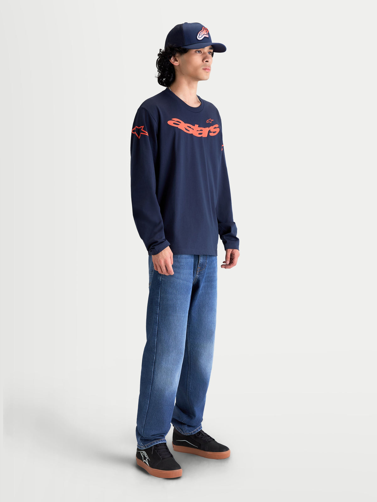 Alpinestars Velocifier CSF Tee, Men's Long Sleeve Sportswear Shirt in Navy Blue and Orange, Cotton and Recycled Polyester blend with curved Astars graphic and shoulder logos, modeled for casual lifestyle wear.
