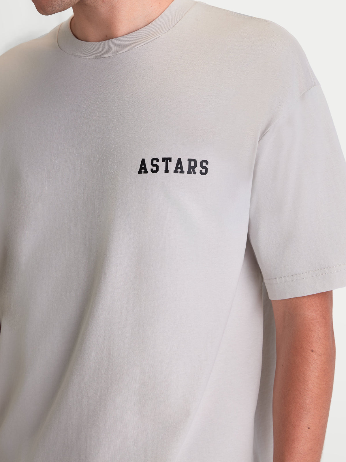 Alpinestars Latitude Oversized CSF Tee, Short Sleeve Sportswear T-Shirt, Cement Gray with Black ASTARS chest wordmark, Casual Relaxed Fit, soft 60/40 cotton-poly blend, seen on model.