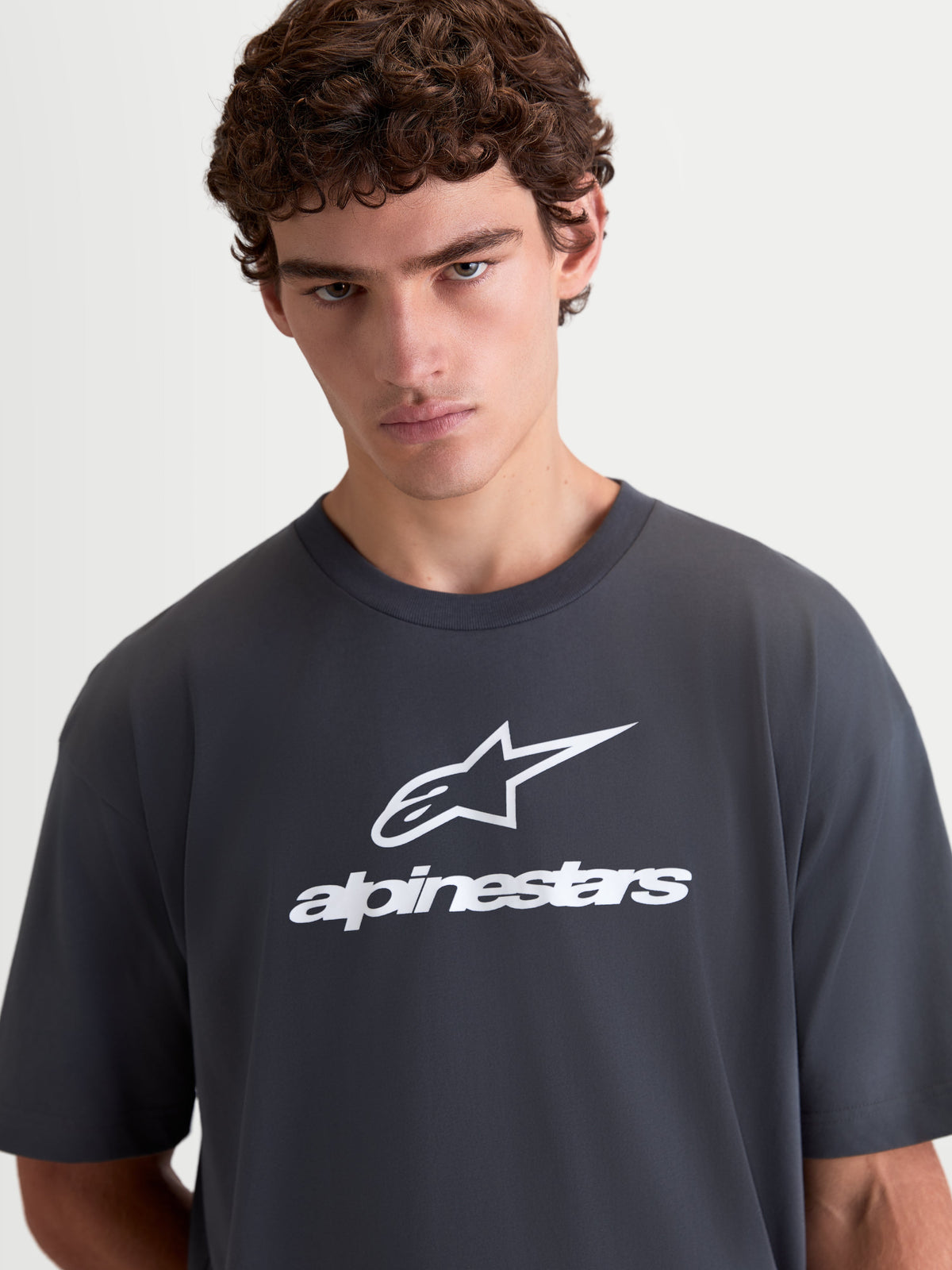 Alpinestars Prelude Oversized CSF Tee, Men's Sportswear Short Sleeve T-Shirt, Charcoal Gray and White, featuring a relaxed fit with front logo graphic and soft cotton-poly construction.