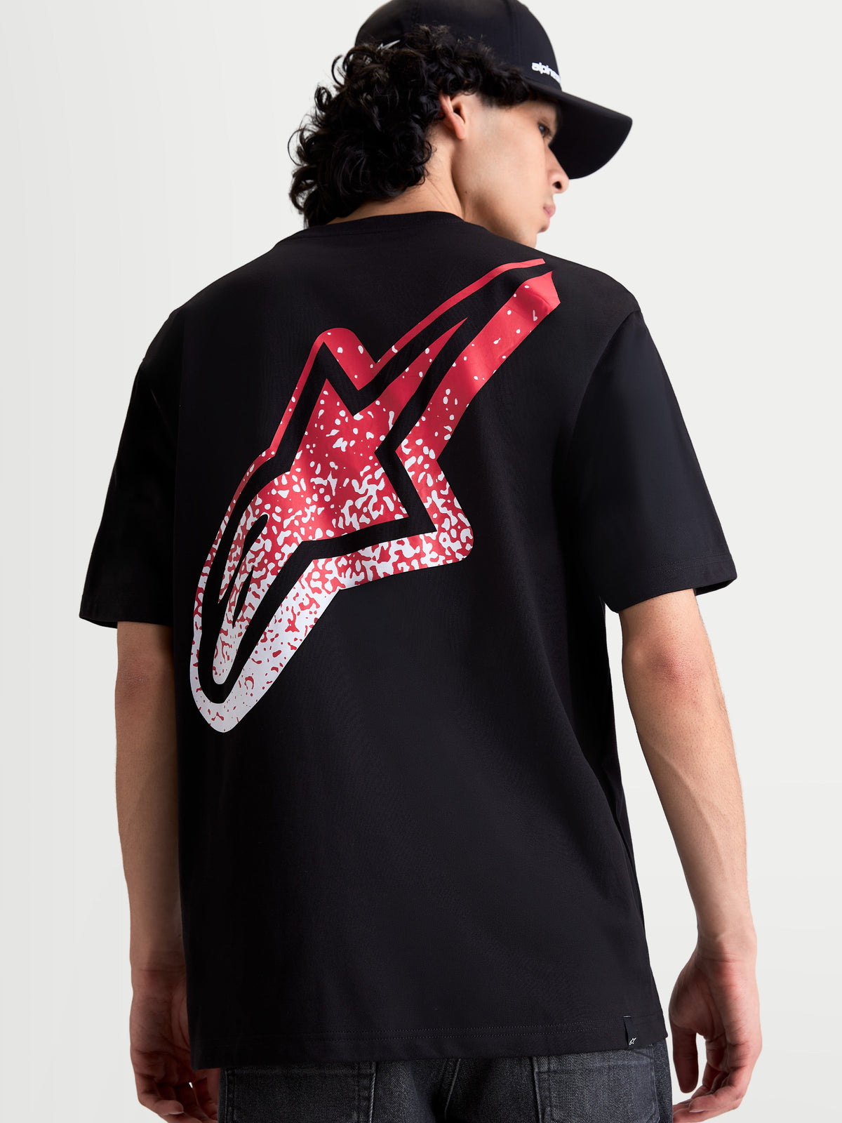 Alpinestars Meteor CSF Tee, Short Sleeve Sportswear T-Shirt, Black with large red and white MX-inspired gradient Astars logo on the back, premium cotton-poly blend, on-model view.