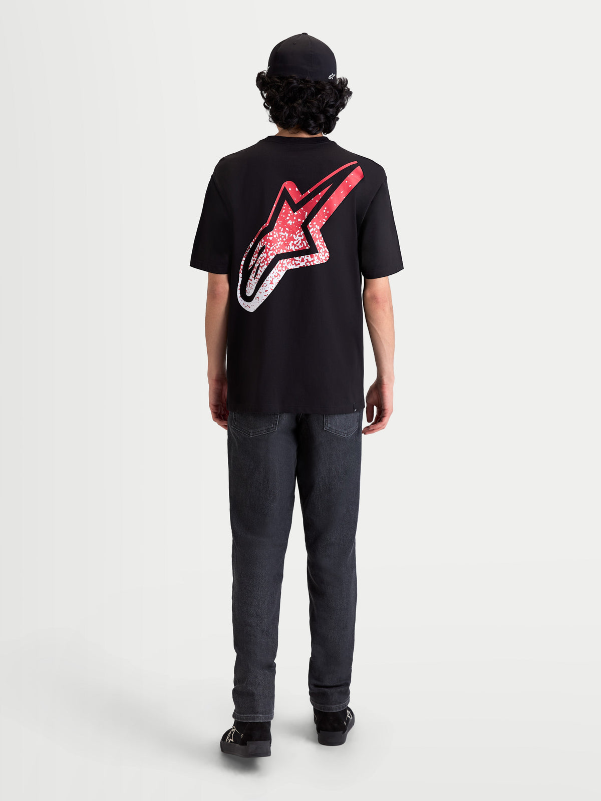 Alpinestars Meteor CSF Tee, Short Sleeve Sportswear T-Shirt, Black, Red, and White. On-model rear view featuring a large back Astars logo with an MX-inspired red and white gradient graphic.