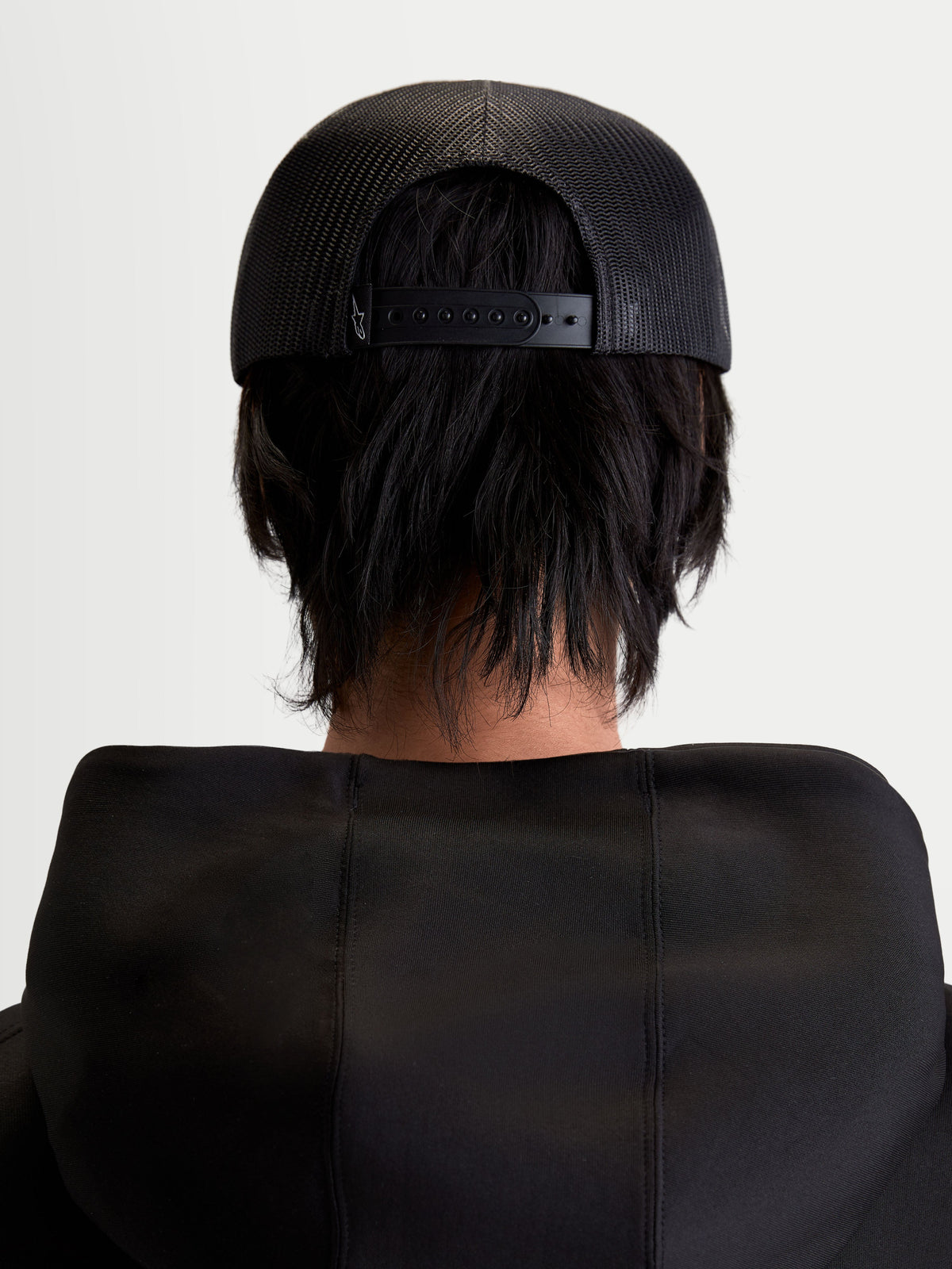 Alpinestars Gravel Trucker Hat, Sportswear Snapback Cap, Unisex, Black, Rear View on Model showing the Breathable Poly Mesh Back and Adjustable Snapback Closure.