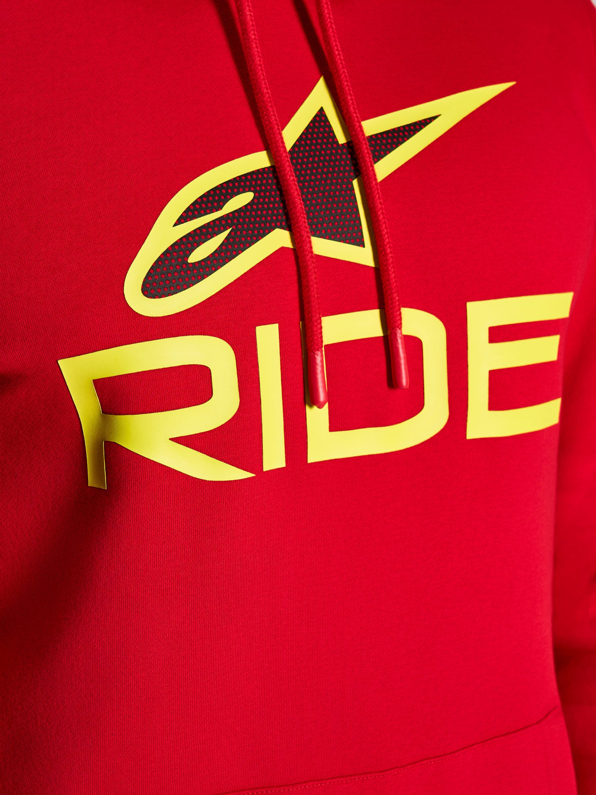 Alpinestars Ride V3 Hoodie, close-up of chest graphic, Red with Hi-Vis Yellow RIDE text and black perforated star logo, red drawstrings with dipped tips, premium fleece casual streetwear