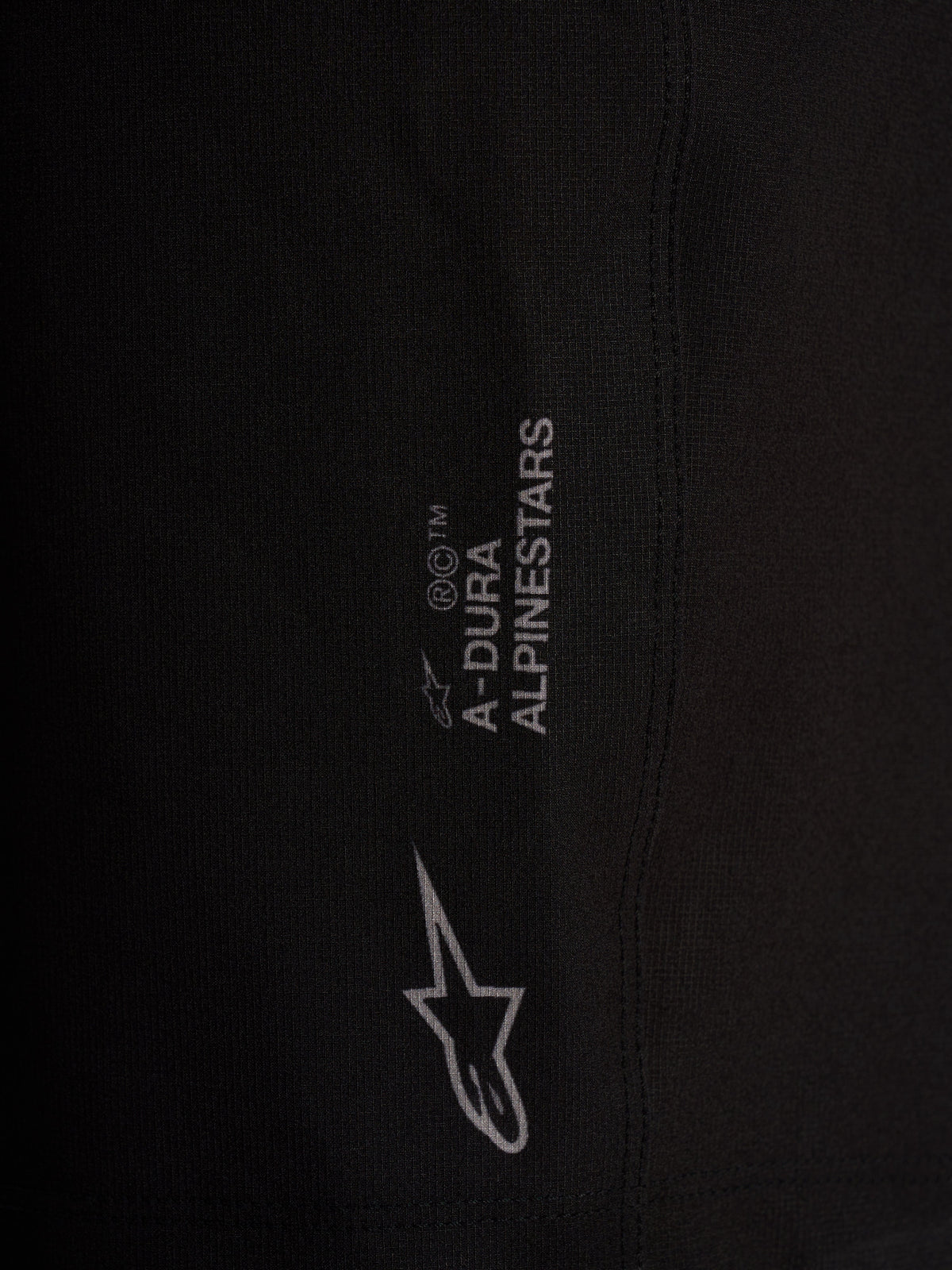 Detail of black Alpinestars A-Dura Ride Liner Shorts with white logos on 4-way stretch performance cycling fabric.