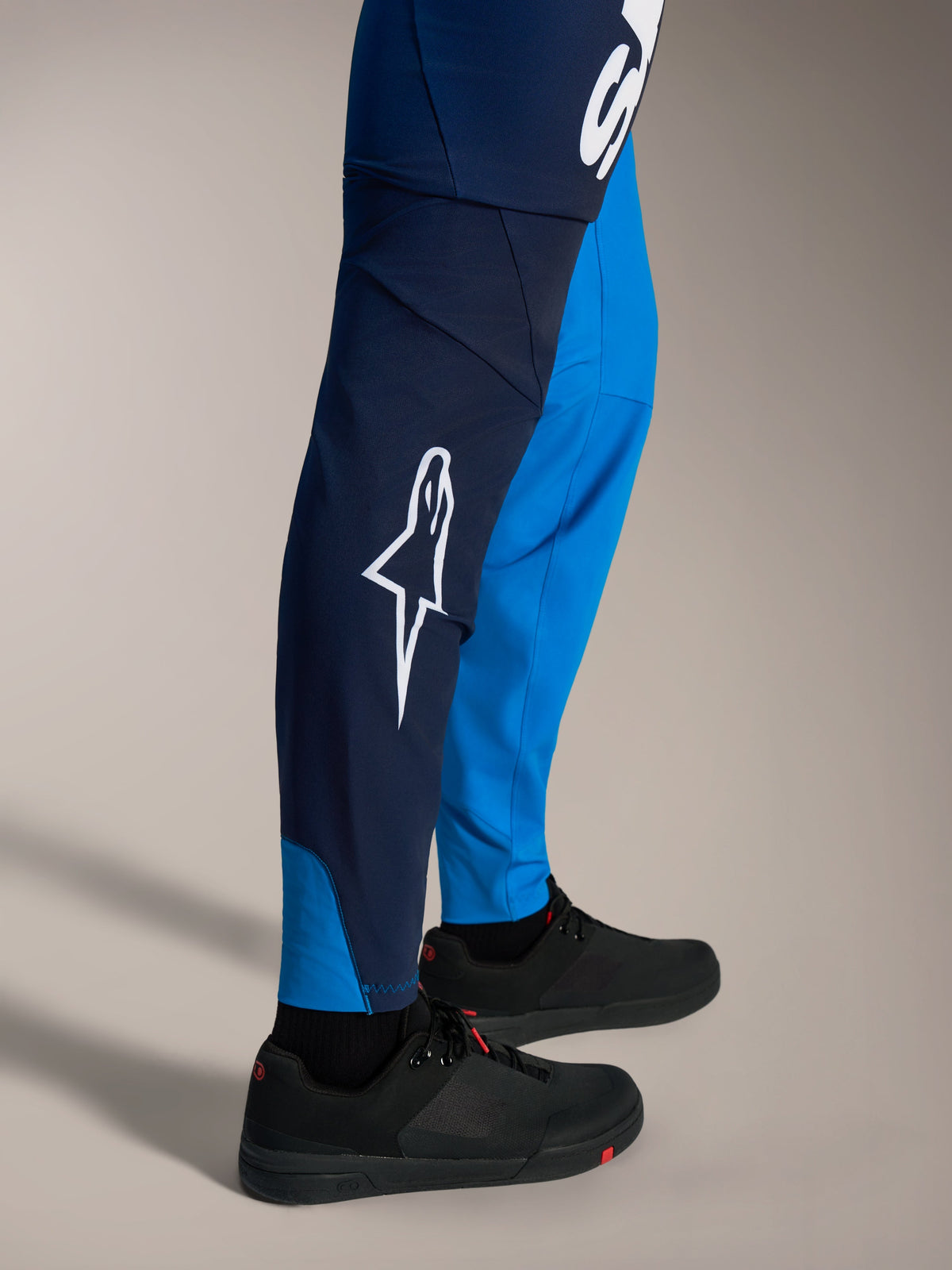 A-Supra Elite MTB Pants in faded bright blue, featuring a bold white Astars logo and slim-fit racing construction.