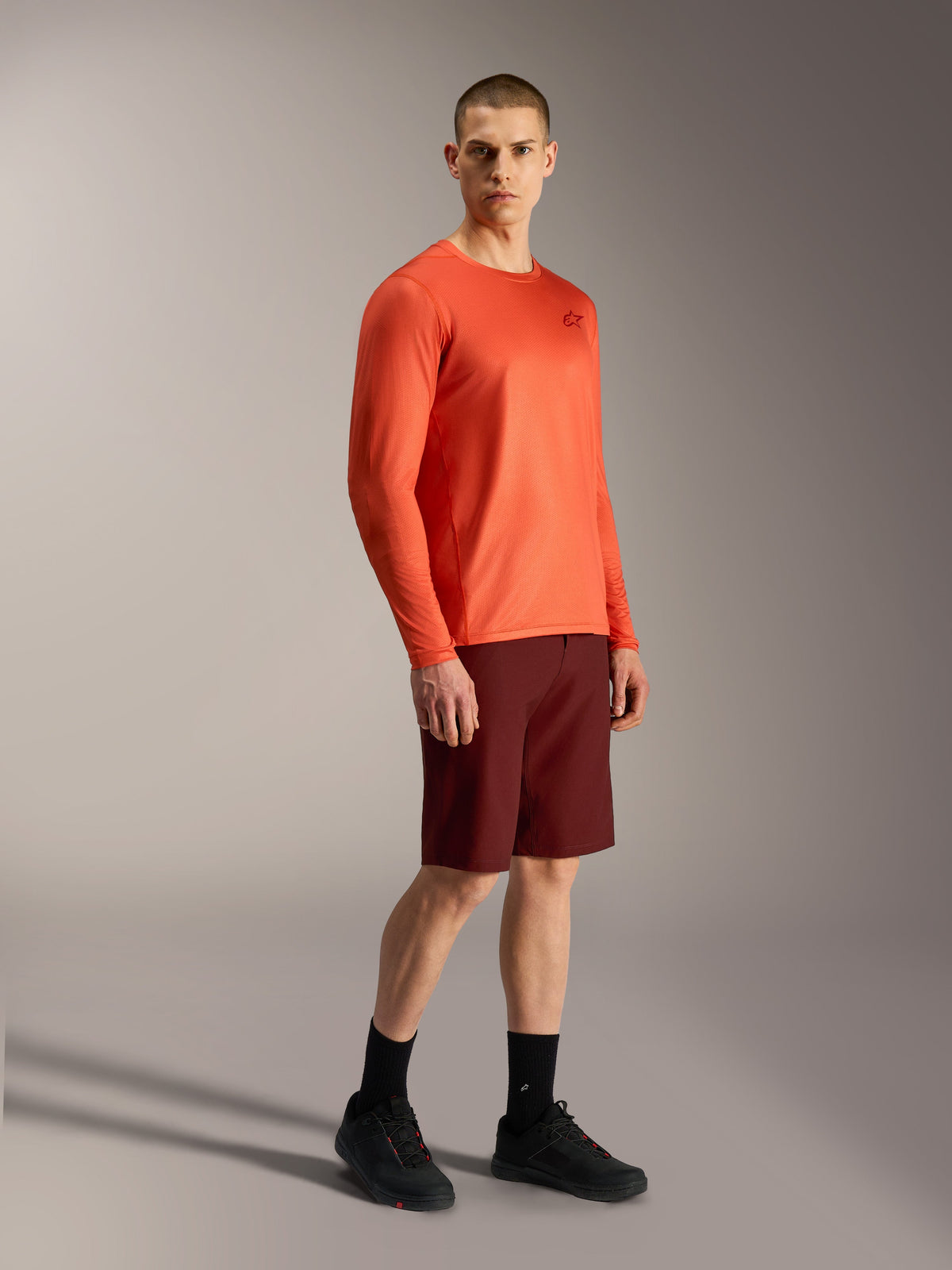 Alpinestars A-Dura Air LS Jersey in bright orange and Bordeaux A-Dura Ride Shorts, performance mountain bike apparel.
