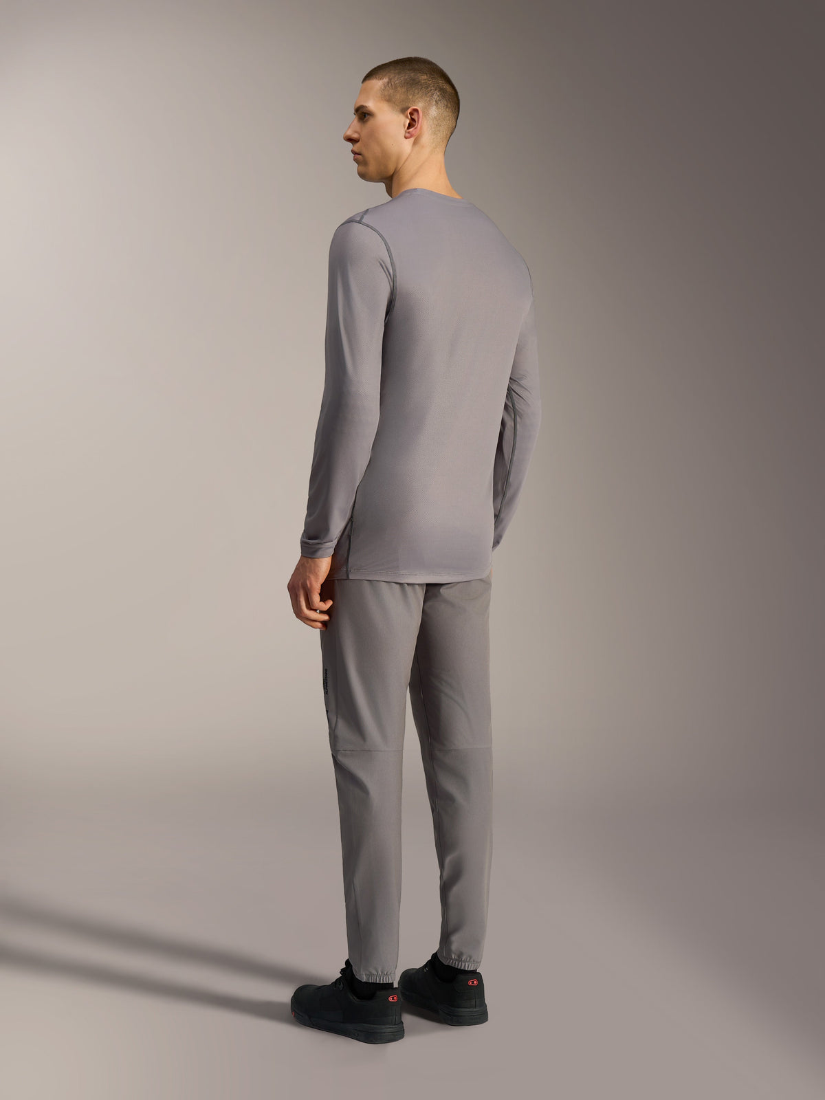 Gray A-Dura Ride Long Sleeve MTB Jersey with a tonal camo pattern and performance stretch fabric, shown from the back.