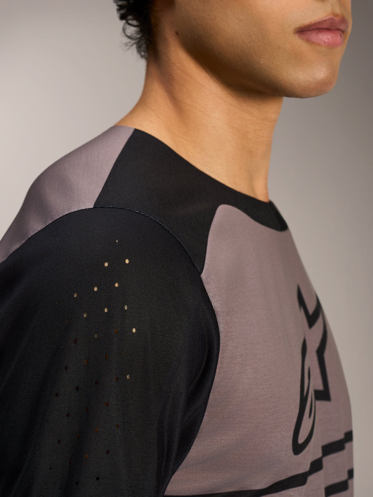 A-Dura Elite Jersey 2.0 in Black, highlighting ventilated perforated sleeves and bonded collar for MTB trail riding.
