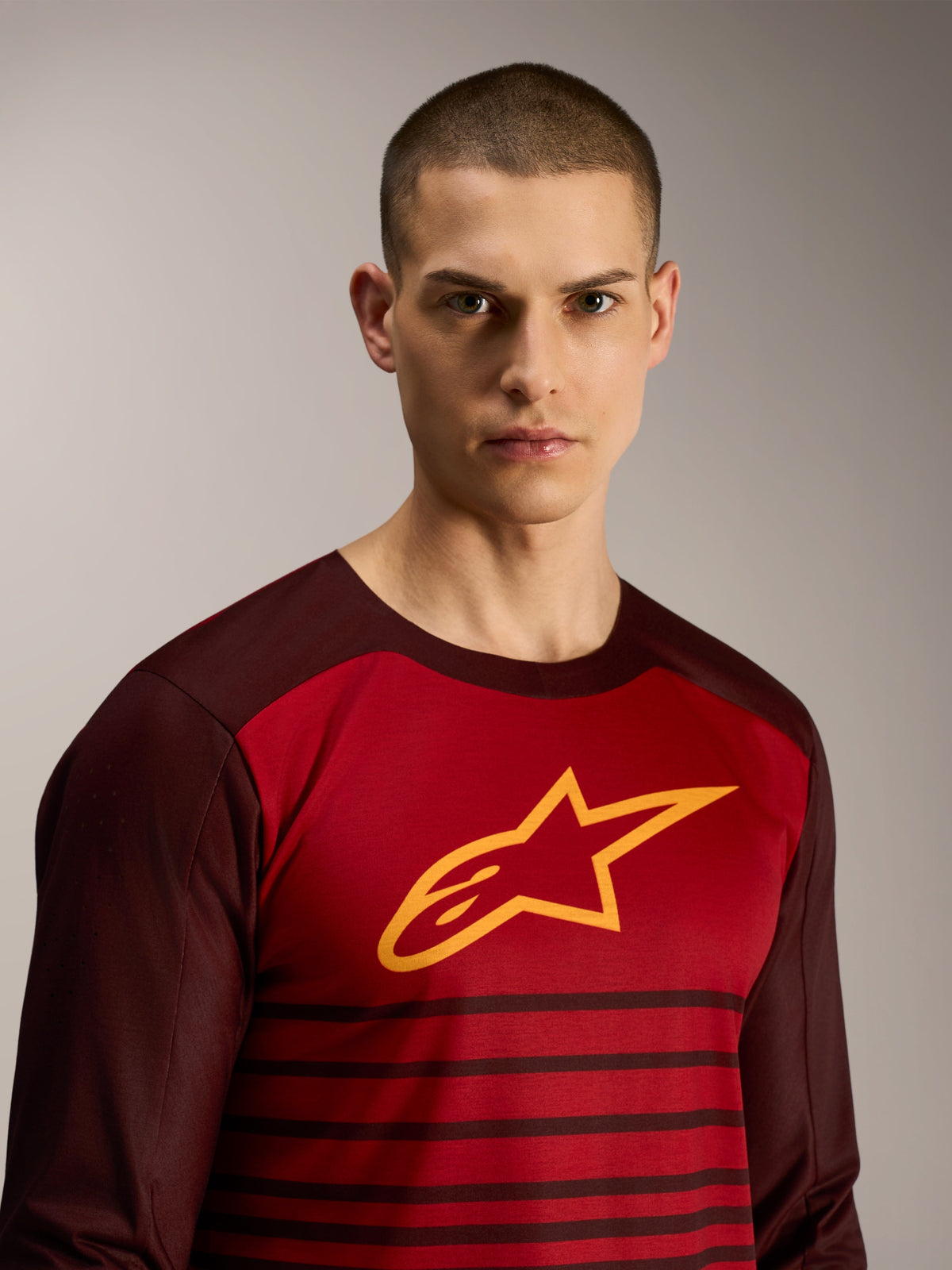 A-Dura Elite Long Sleeve Jersey in Bordeaux, featuring a yellow star logo and striped pattern for MTB performance.
