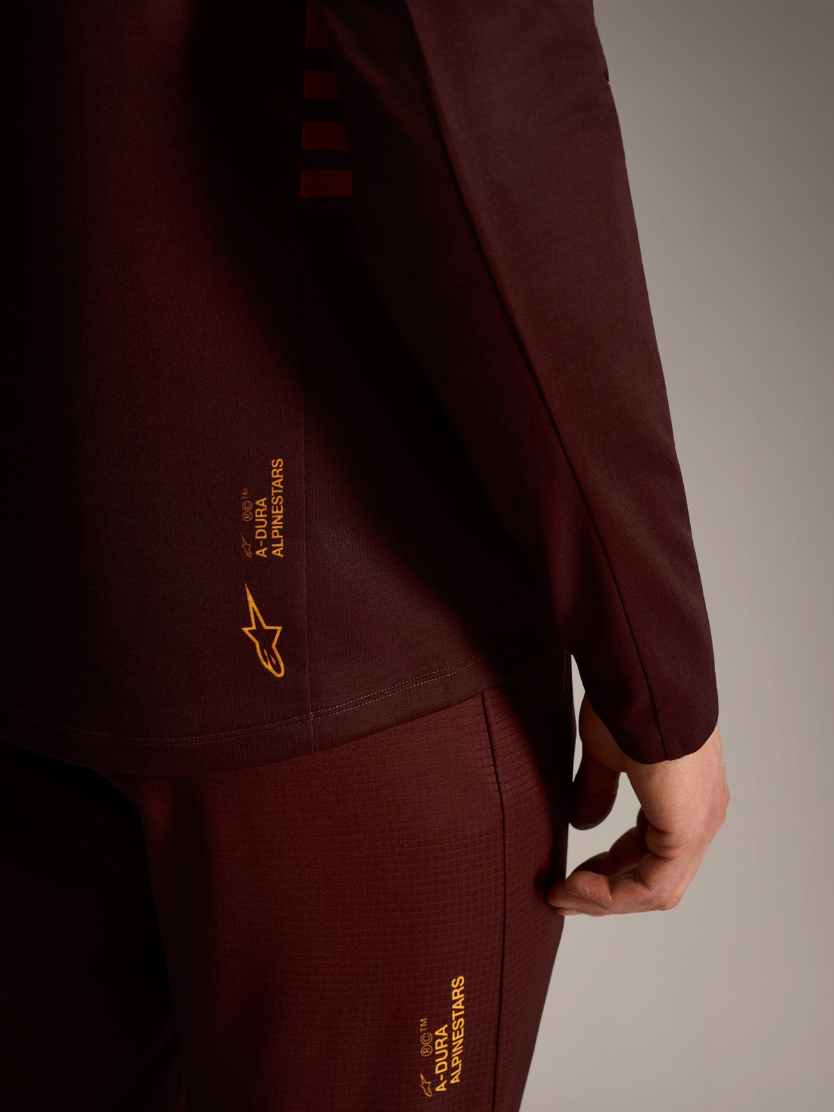 A-Dura Elite Long Sleeve Jersey in Bordeaux, featuring yellow Alpinestars branding, technical trail-ready performance gear.