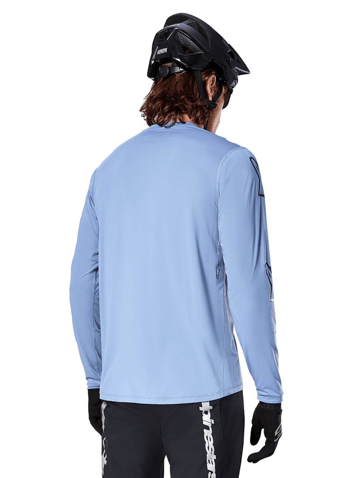 Alpinestars A-Dura Switch Long Sleeve Jersey, Infinity Blue, rear view of mountain bike rider wearing a black helmet and shorts, casual performance cycling apparel with a drop-tail hem.