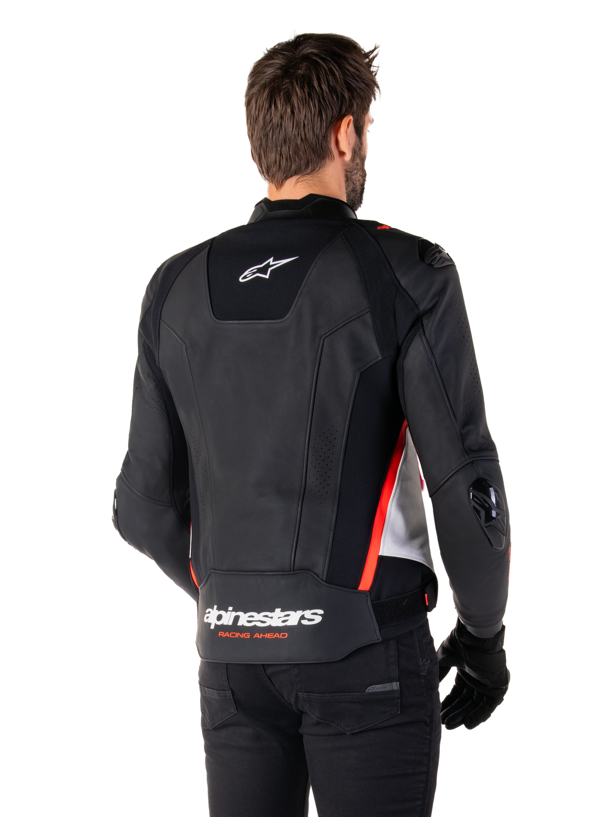 Alpinestars Missile V3 Leather Jacket, back view on a rider, Black White and Red Fluo, featuring bold Alpinestars branding and 'RACING AHEAD' text on the lower back, premium leather construction with technical stretch panels and protective TPU sliders, worn with black gloves and trousers.