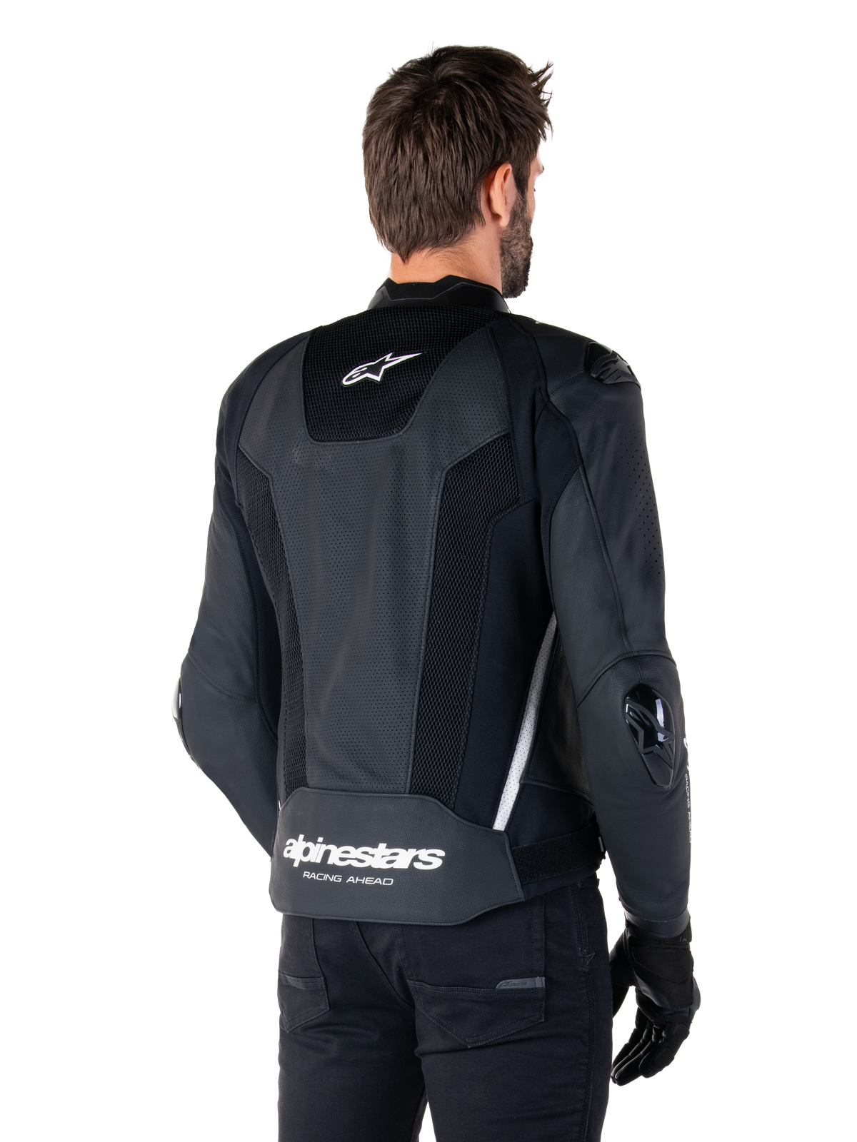 Alpinestars Missile V3 Airflow Leather Jacket, Black and White, rear view featuring perforated leather and mesh panels for maximum ventilation, white Alpinestars branding on lower back and star logo on neck, worn with black riding gear, premium racing sport design.
