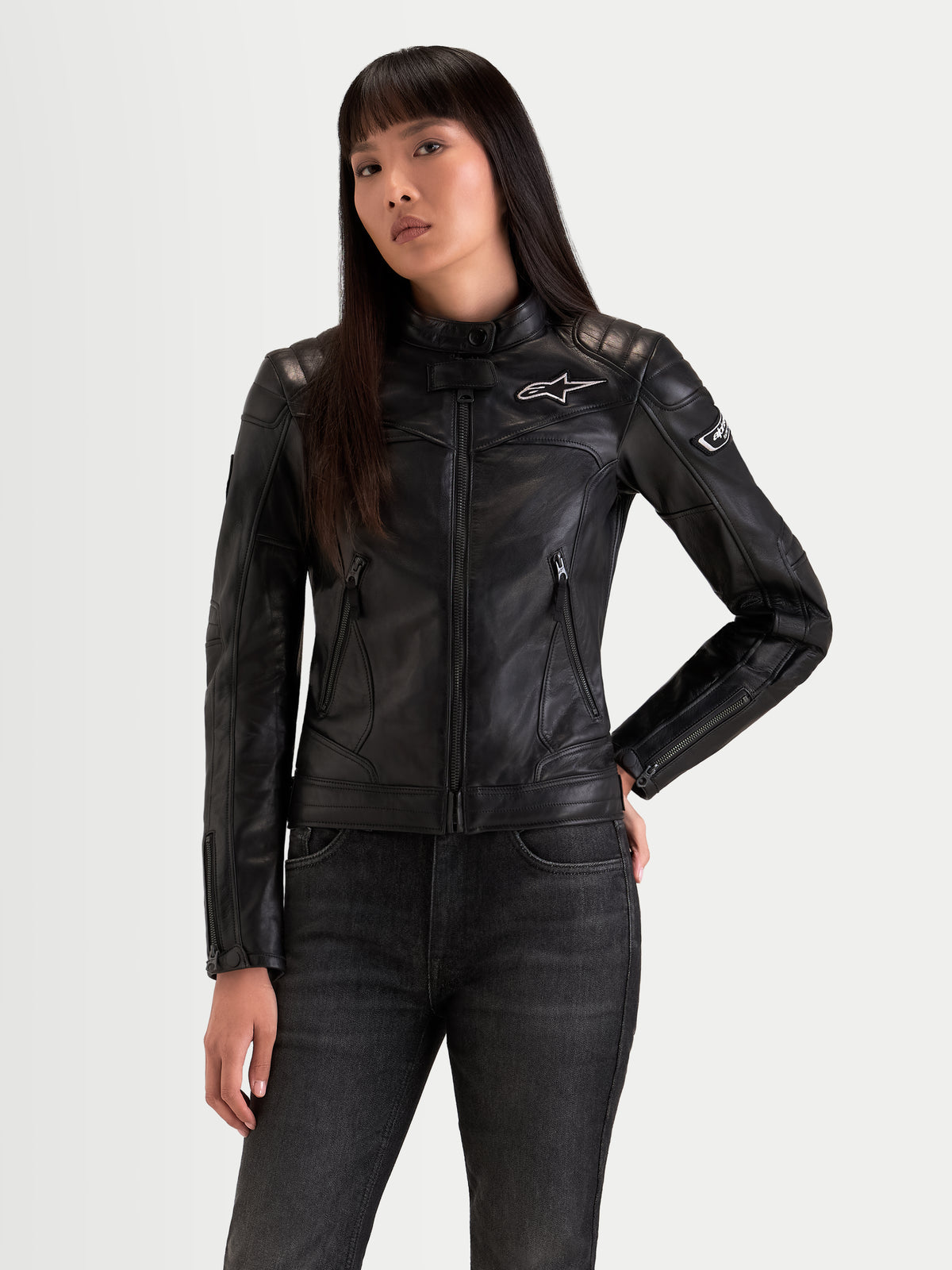 Alpinestars Revea Women Leather Jacket, women's urban contemporary motorcycle jacket in black, premium full-grain leather construction worn by a model, featuring shoulder and elbow padding and heritage styling.