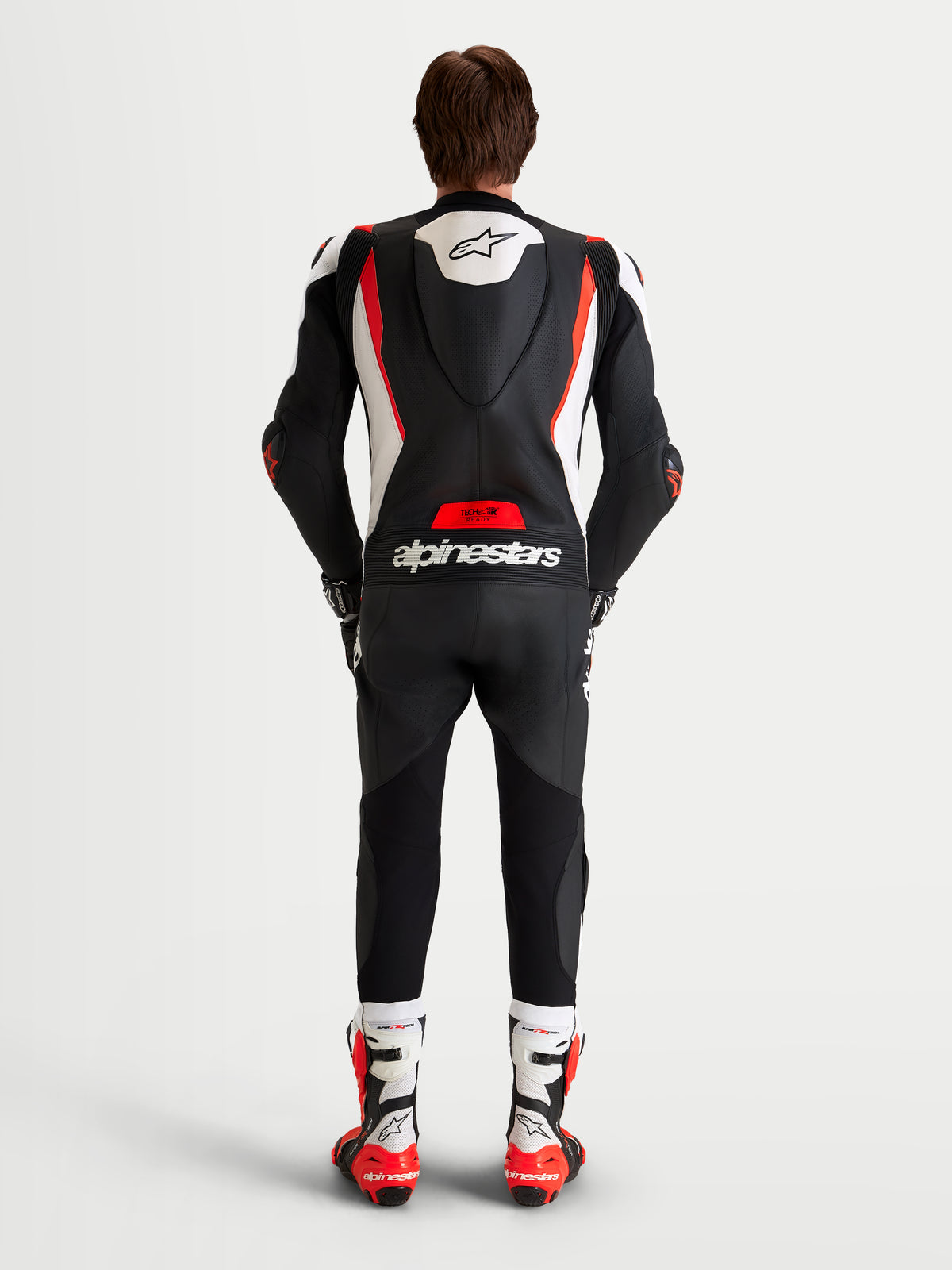 Alpinestars Missile V3 1-Piece Leather Suit, Men's motorcycle racing suit, Black, White and Red Fluo, featuring AAA-rated leather construction, aerodynamic speed hump, and race-ready protection, shown from the rear