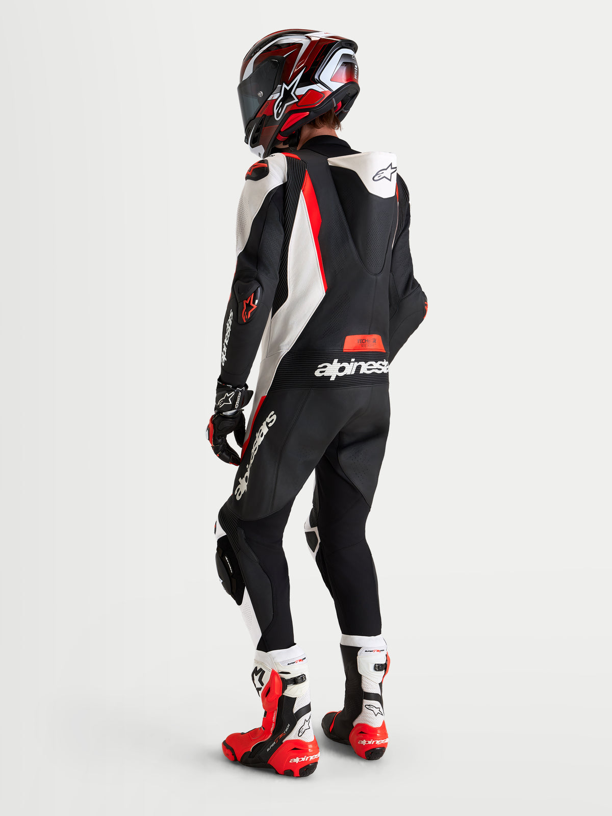 Alpinestars Missile V3 Leather Suit - 1 Piece, men's motorcycle racing suit, Black White Red Fluo, featuring AAA-rated leather, aerodynamic speed hump, and CE-certified protection, shown worn on a model from the rear view