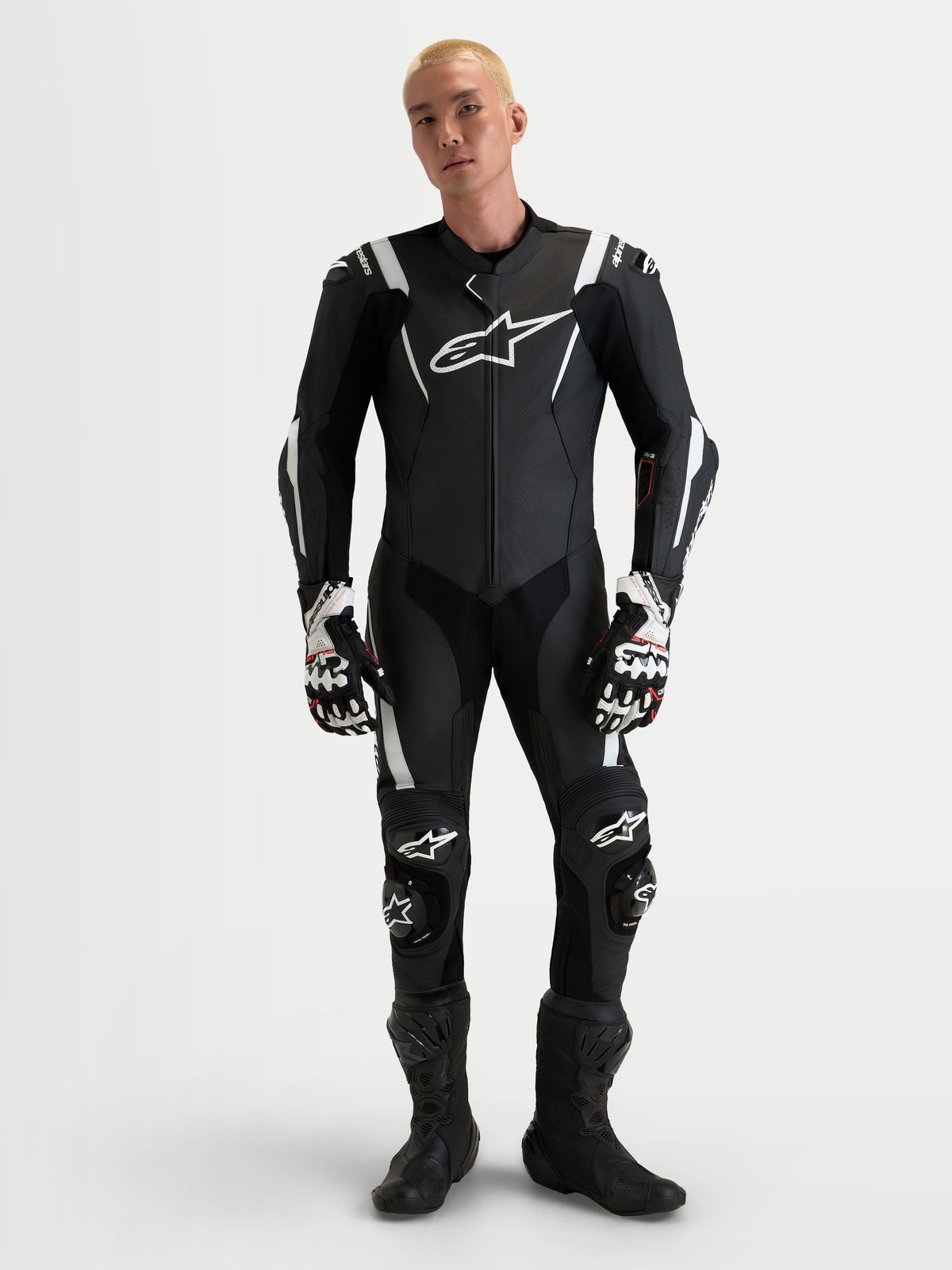 Alpinestars Missile V3 Leather Suit 1 Piece, men's black and white AAA-rated race leather suit with integrated DFS ST armor and CE certification, worn by a model