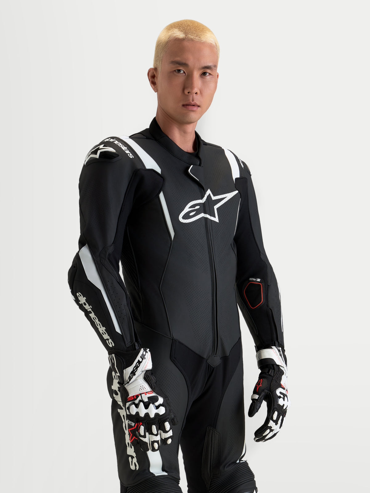 Alpinestars Missile V3 Leather Suit - 1 Piece, men's black and white motorcycle racing leather suit featuring integrated shoulder and elbow protection, aerodynamic design, and matching race gloves
