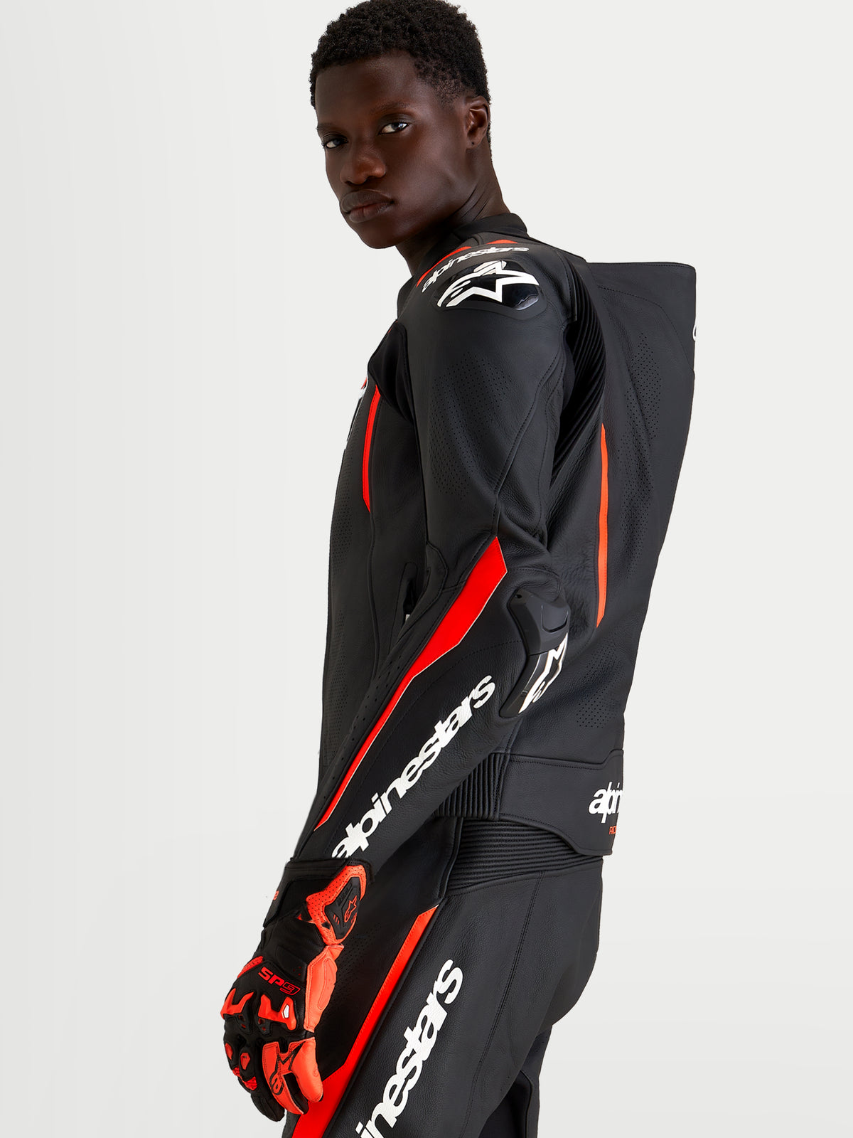 Alpinestars Missile V3 Leather Suit 2 Piece, Black and Red Fluo, men's racing leather suit with aerodynamic speed hump and DFS armor, on-model view