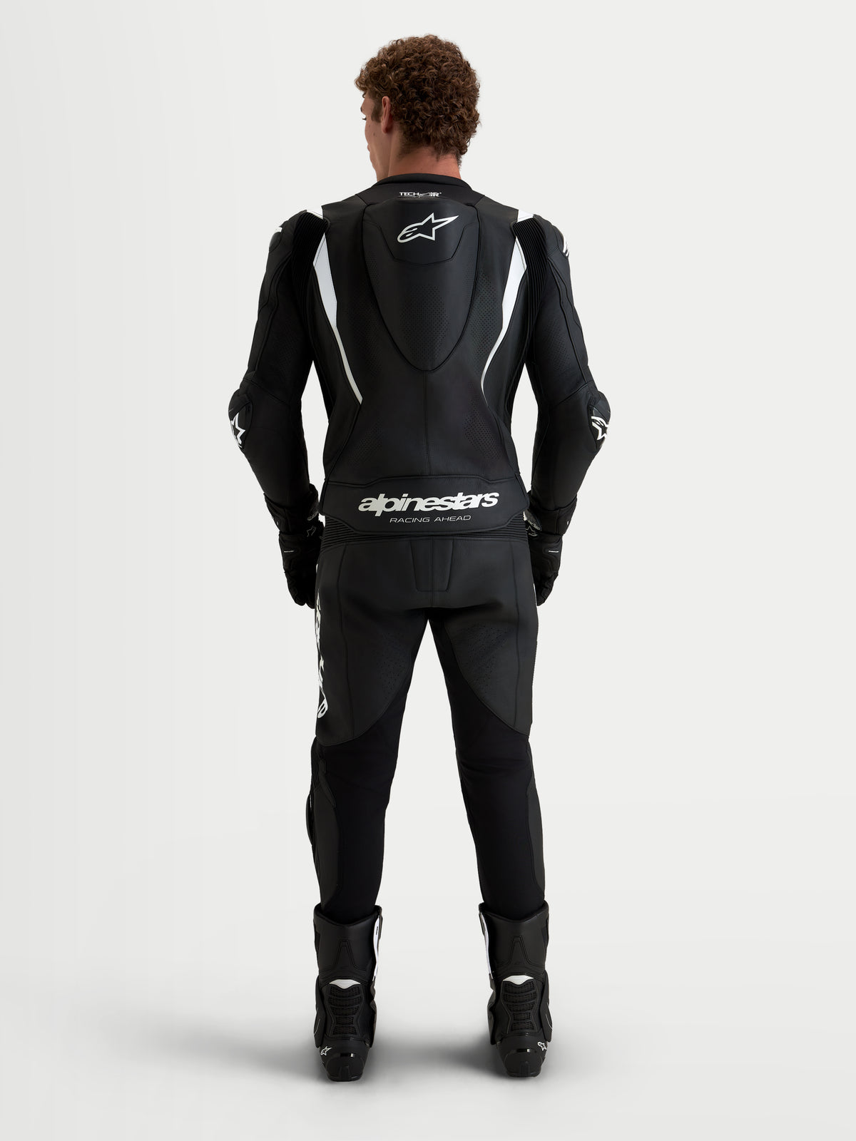 Alpinestars Missile V3 Leather Suit 2-Piece, Men's Motorcycle Racing Suit in Black and White, rear view showing aerodynamic speed hump with Alpinestars branding, perforated leather construction, and CE certification