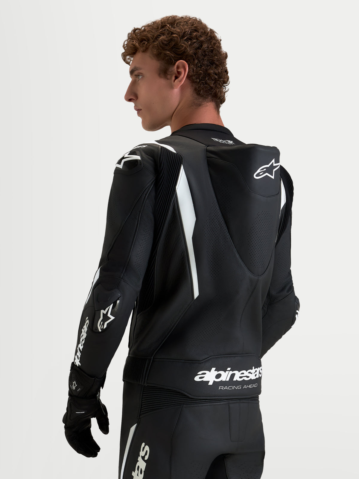 Alpinestars Missile V3 Leather Suit 2 Piece, Black and White men's motorcycle racing suit, rear view showing aerodynamic speed hump and DFS shoulder protection