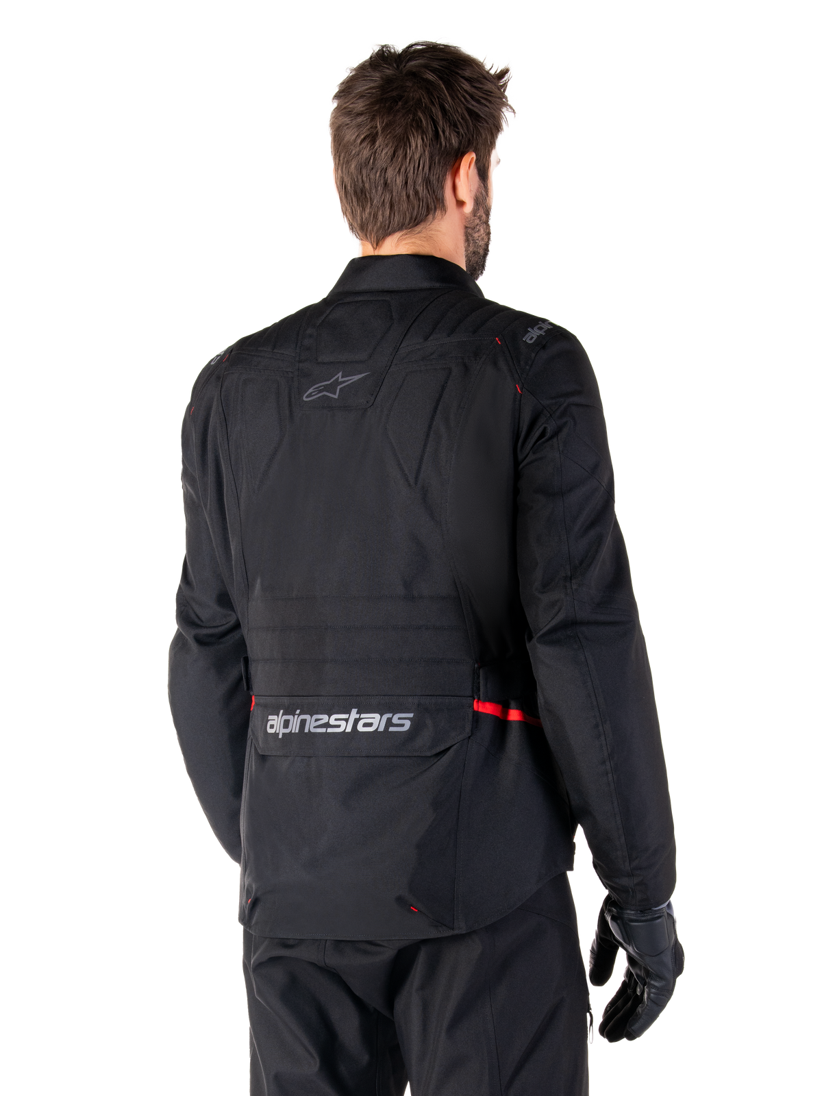Alpinestars ST-1 Waterproof Jacket, Black, rear view on a model, featuring Alpinestars branding on the lower back cargo pocket, subtle red accents, textile adventure touring motorcycle jacket