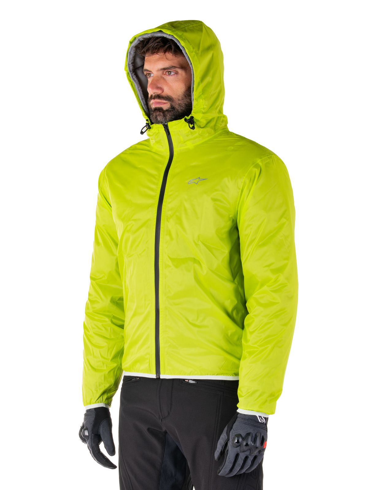 Alpinestars Mohobbs Waterproof Jacket, Lime Punch packable rain liner, bright neon green hooded jacket worn with black pants and gray gloves, urban streetwear-inspired motorcycle apparel